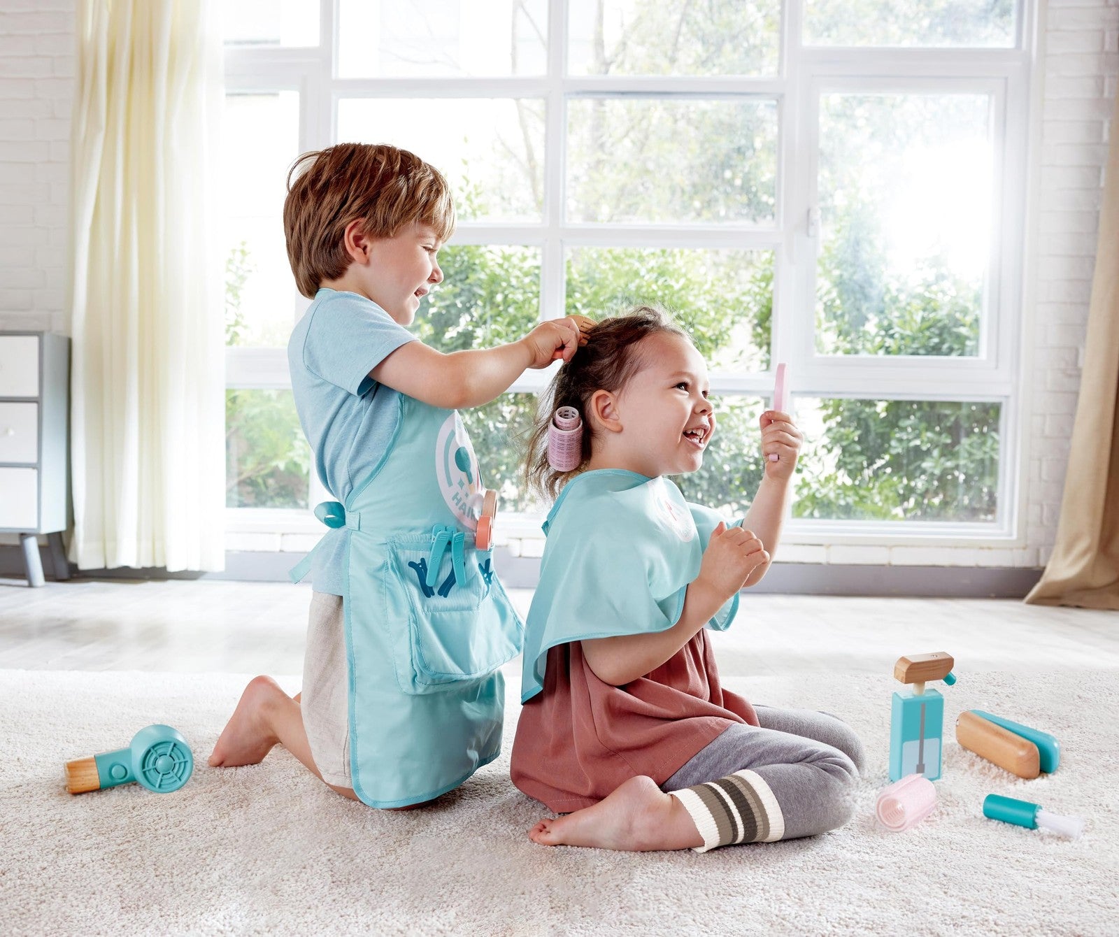 Hape Super Stylish Hair Salon Set for kids, includes toy hair tools, styling accessories, and pretend salon station.