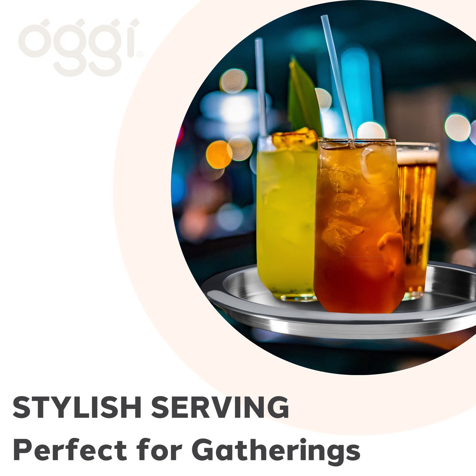 Oggi round steel tray, 14-inch diameter, used as a decorative coffee table, tea tray, or bar serving tray in a modern home interior.
