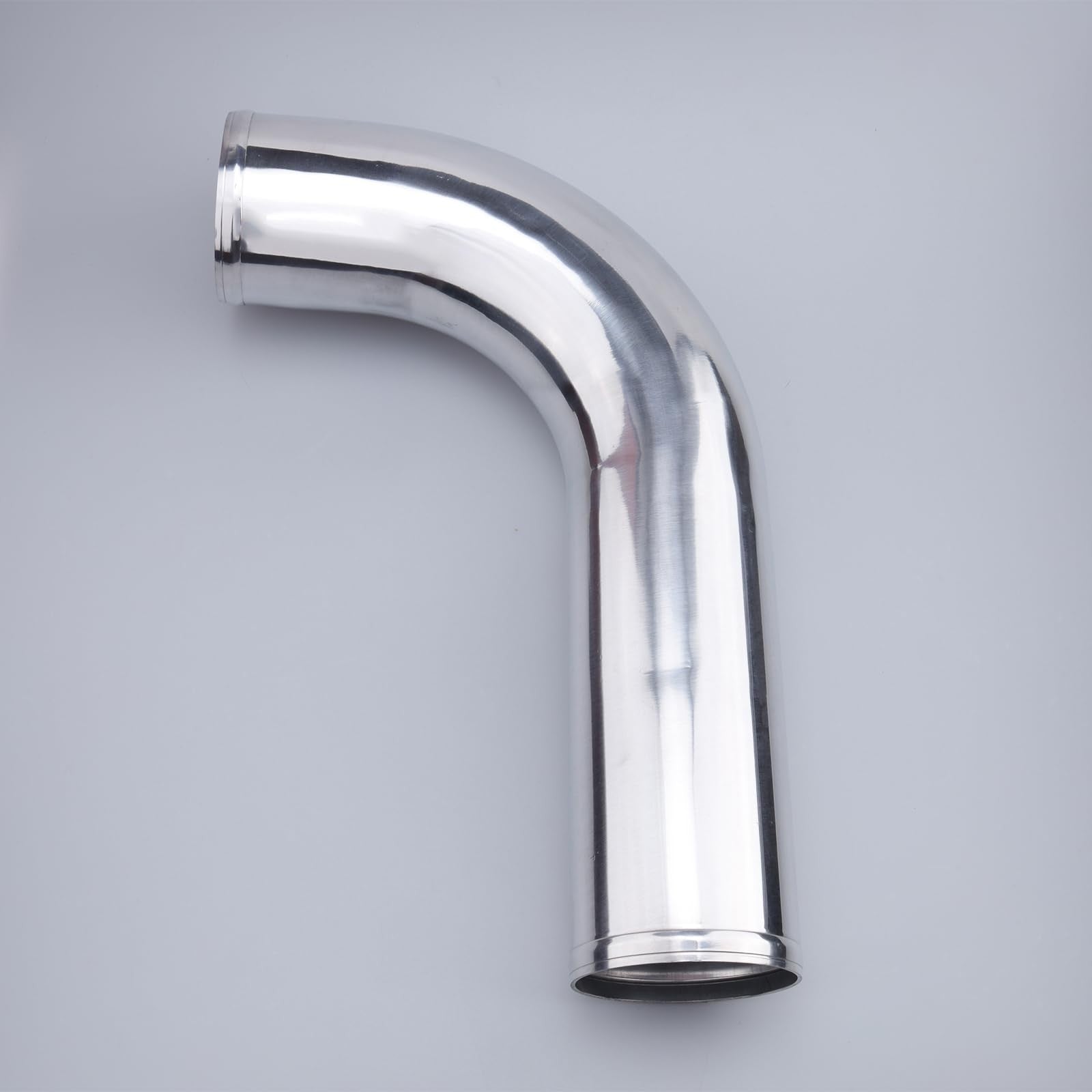 AC PERFORMANCE 3.5-inch OD aluminum intercooler pipe L-bend showing smooth metallic finish and precise 90-degree bend.