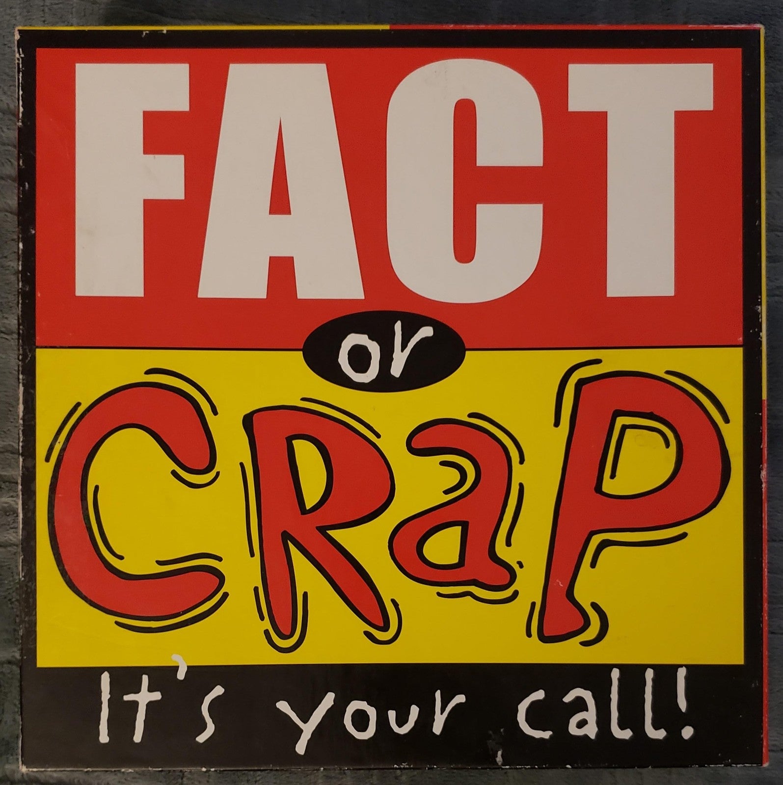 University Games Fact or Crap board game with colorful question cards and game pieces on a table.