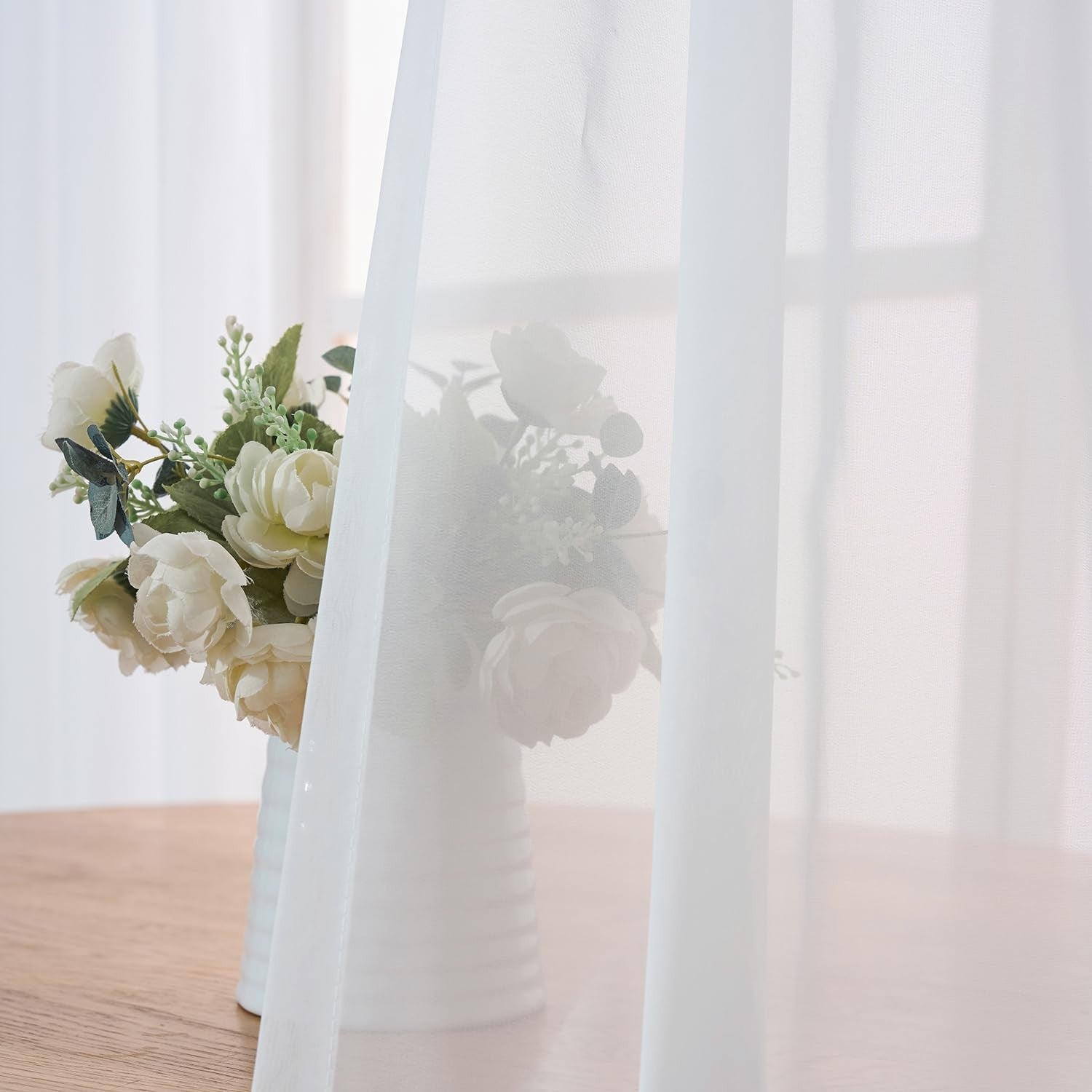 LUGOTAL Pure White 90-inch pinch pleated chiffon sheer curtains hanging smoothly in a window setting.