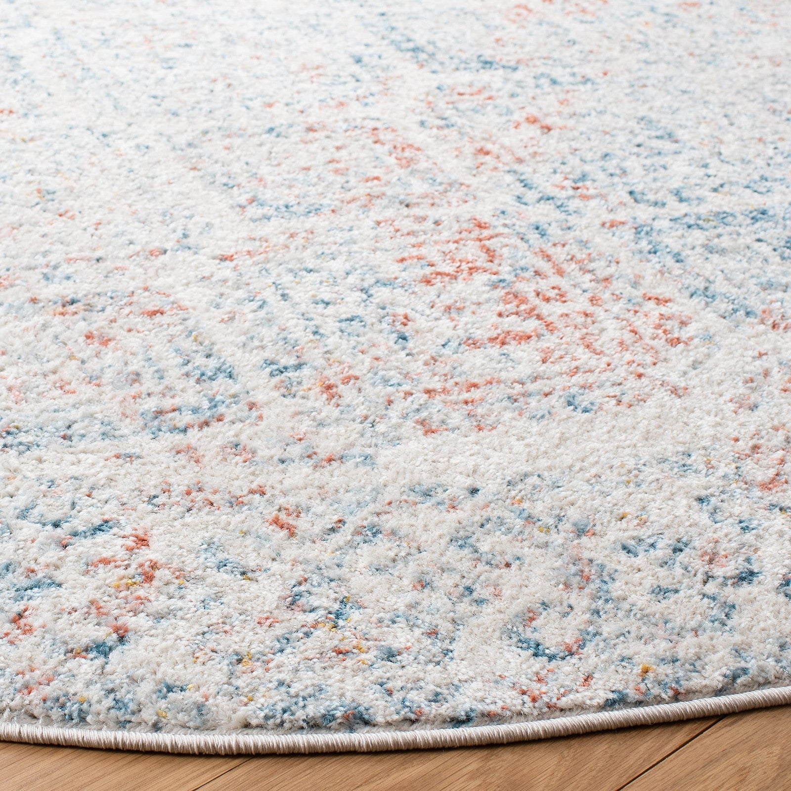 Round ivory and terracotta Moroccan boho area rug from the Safavieh Tulum Collection with intricate patterns.