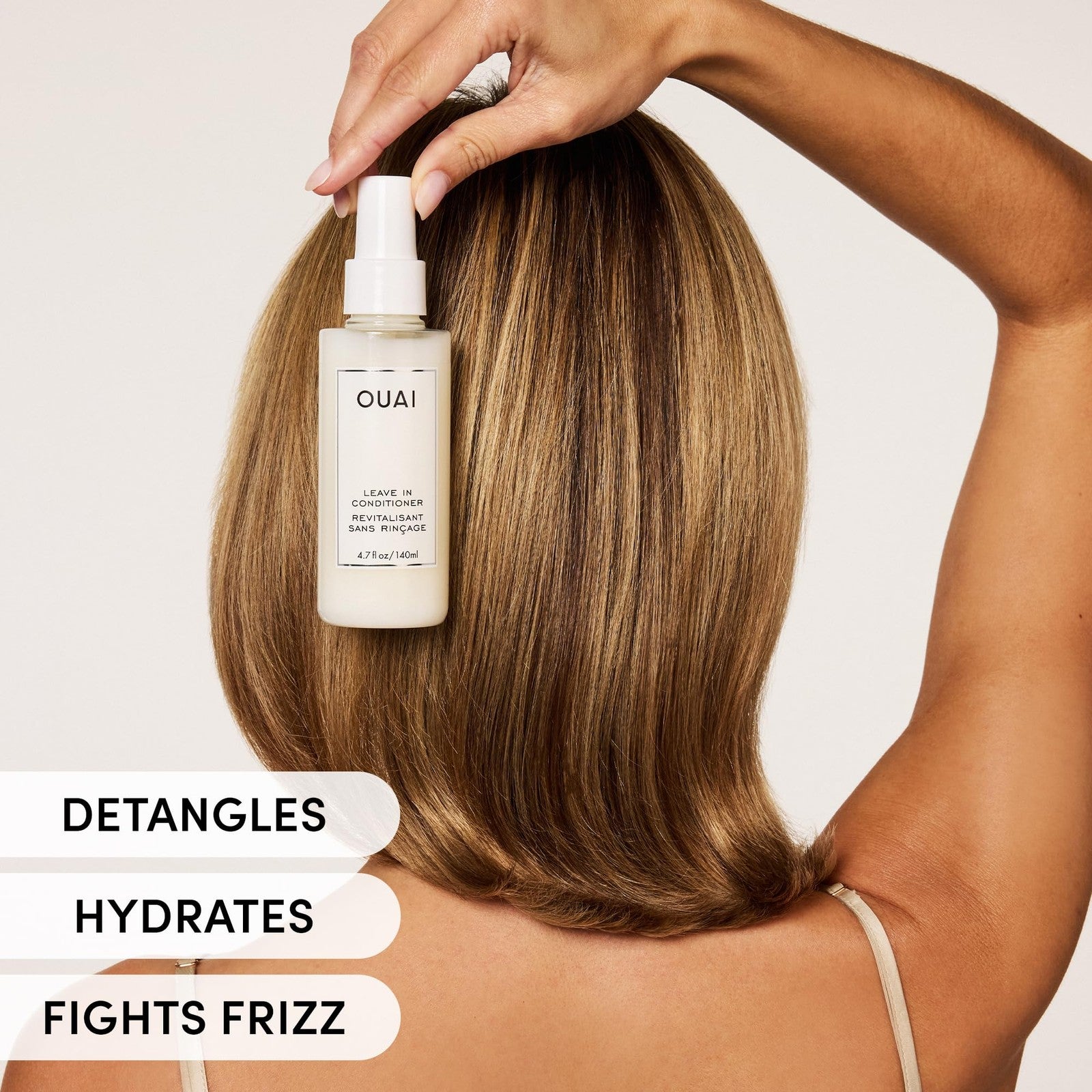 OUAI Leave-In Conditioner and Heat Protectant Spray bottle with frizz control, shine, and detangling benefits for healthy hair.