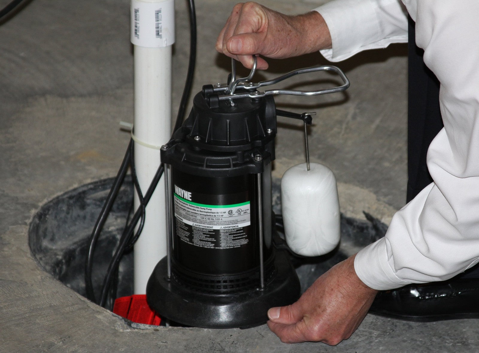 Wayne SPF50-1/2 HP epoxy-coated steel and thermoplastic submersible sump pump, showing the pump's motor and casing details.