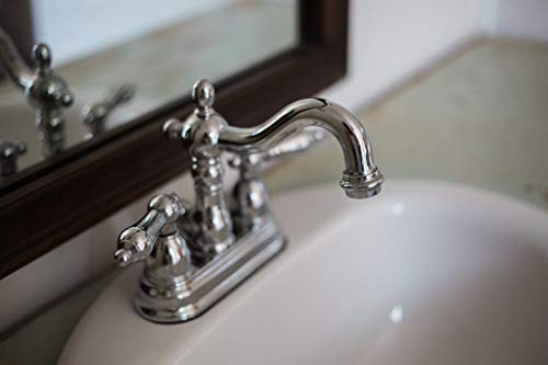 Kingston Brass Heritage 4-inch centerset lavatory faucet with metal lever handles and polished chrome finish.