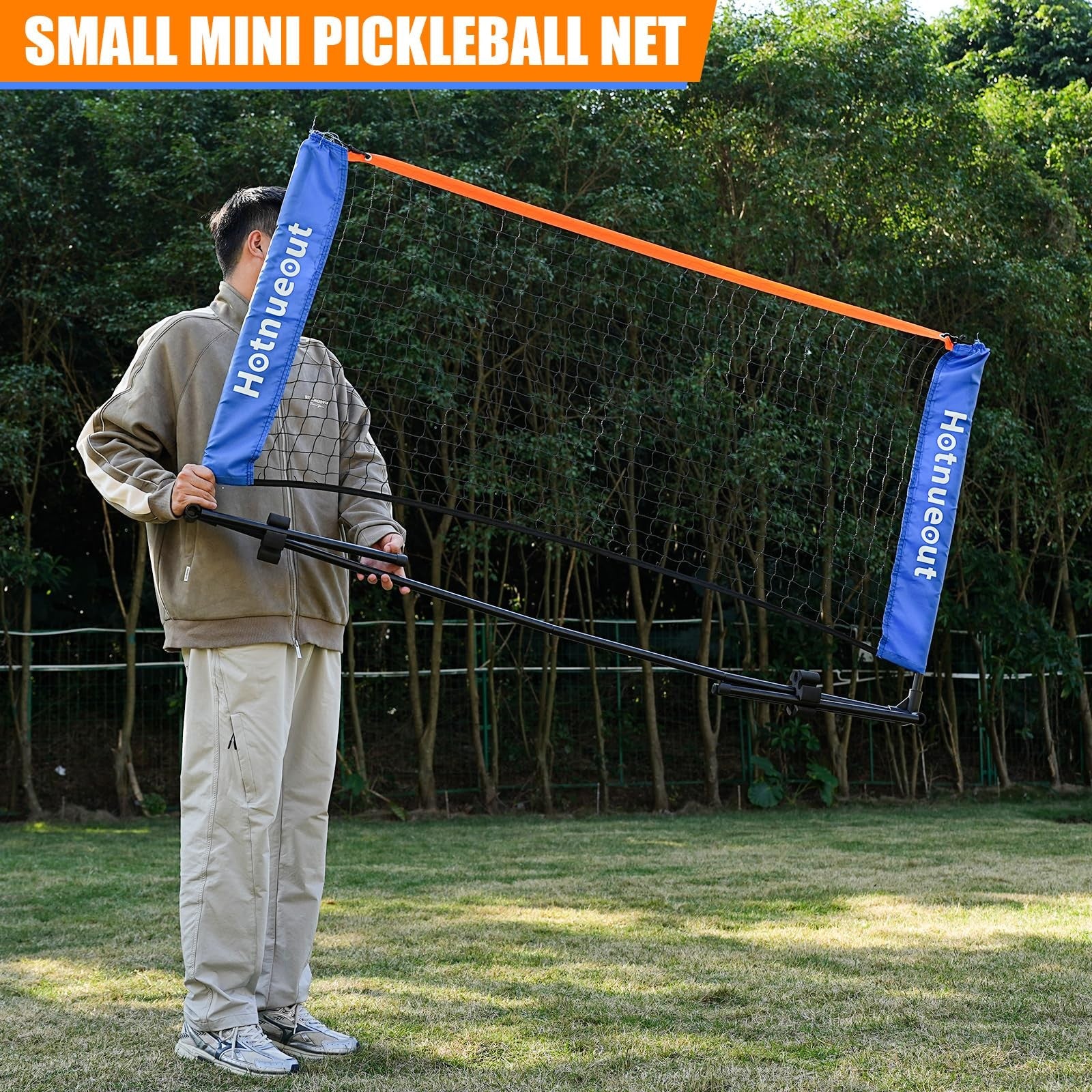 Hotnueout 5FT mini pickleball net, portable practice net set up outdoors in a driveway with a colorful ball and paddle nearby.