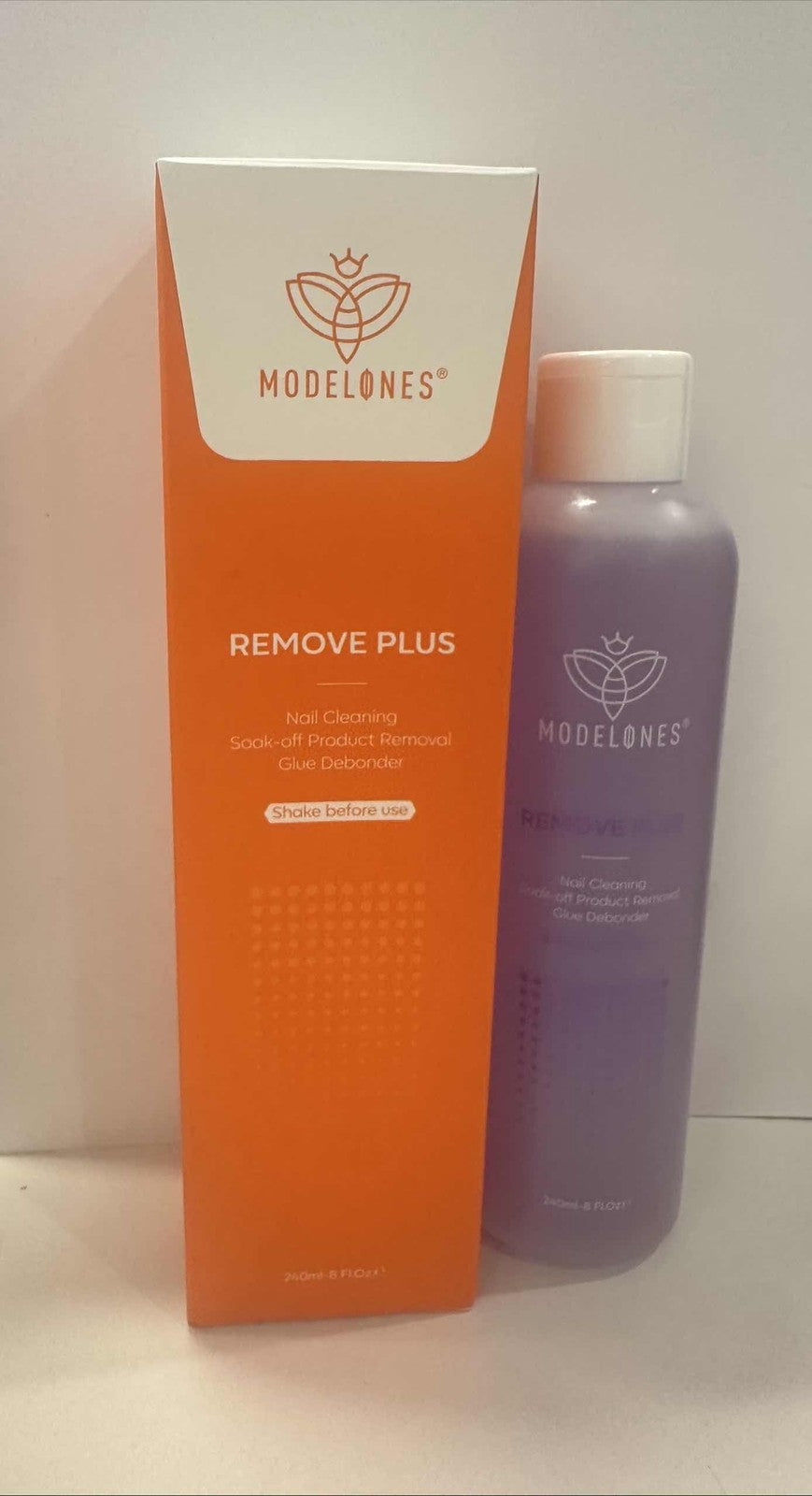 Unbranded Modelones nail polish remover with acetone, featuring a red-orange sky design on the bottle.