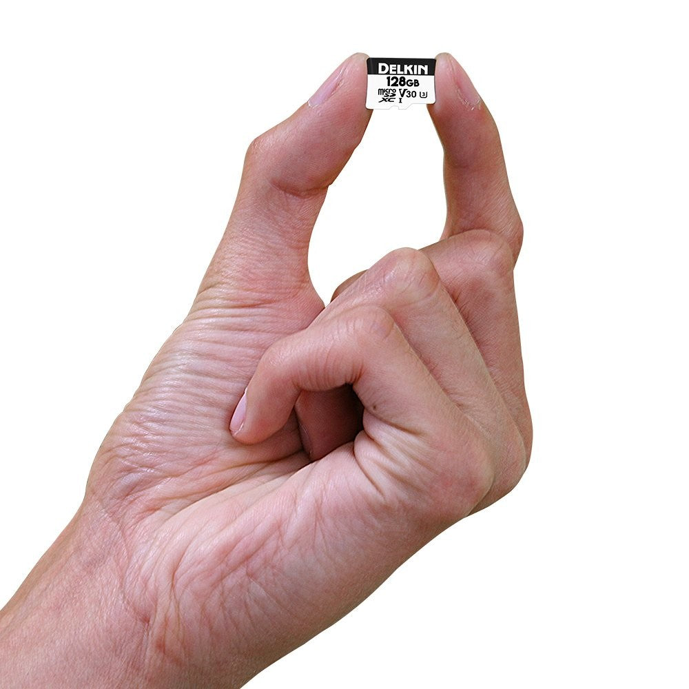 Delkin Devices 128GB Micro SD card with adapter, showing the card and packaging, designed for high-speed data transfer.