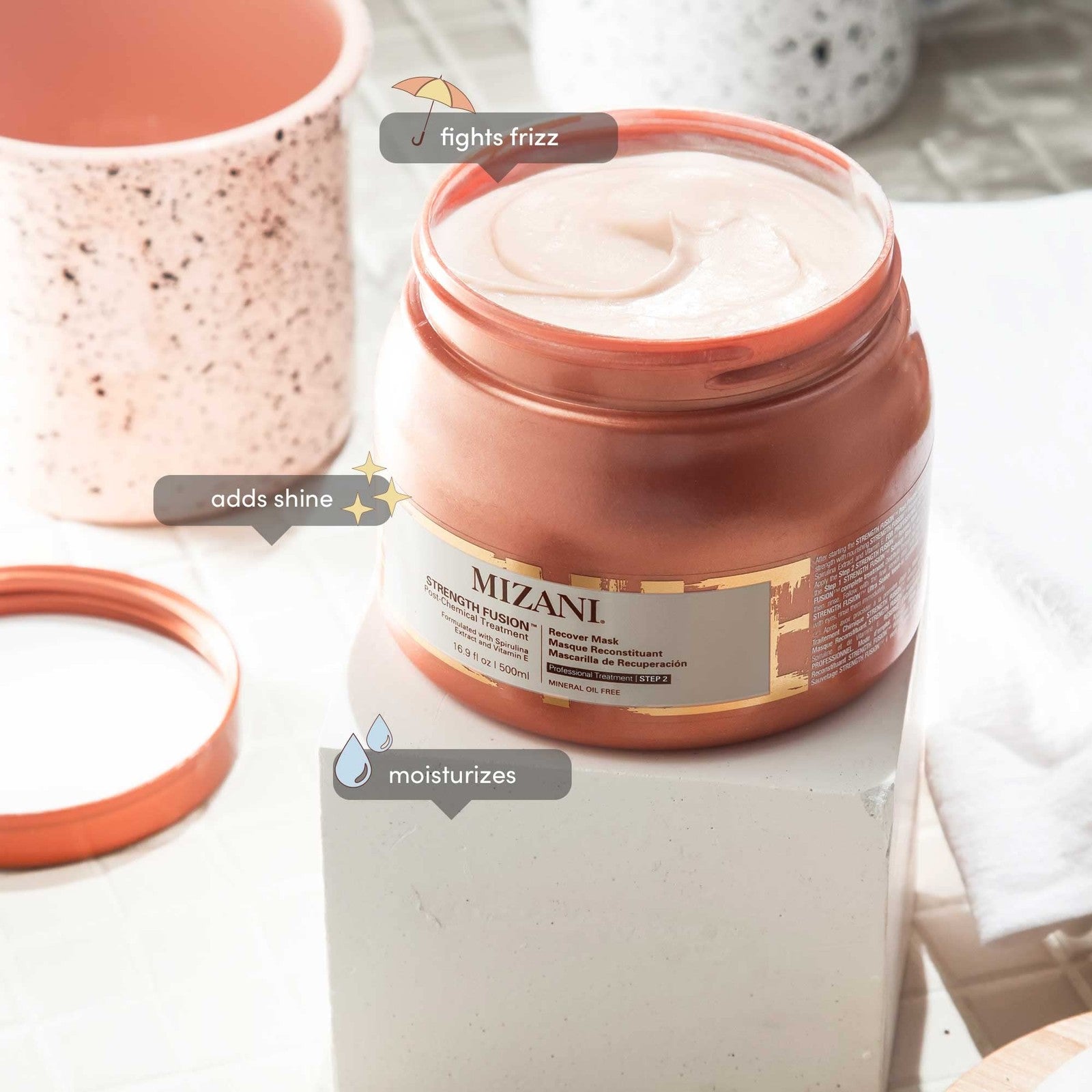 Mizani Strength Fusion Recover Mask for damaged hair, showing a jar of intense night-time treatment with a smooth, creamy texture.