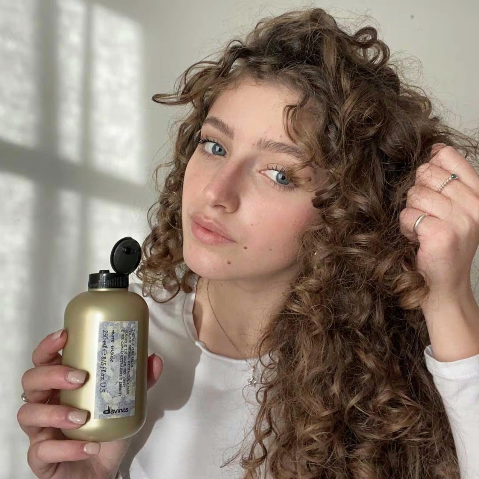 Davines This is a Curl Gel Oil bottle for curly hair, with the product label visible, placed on a white background.