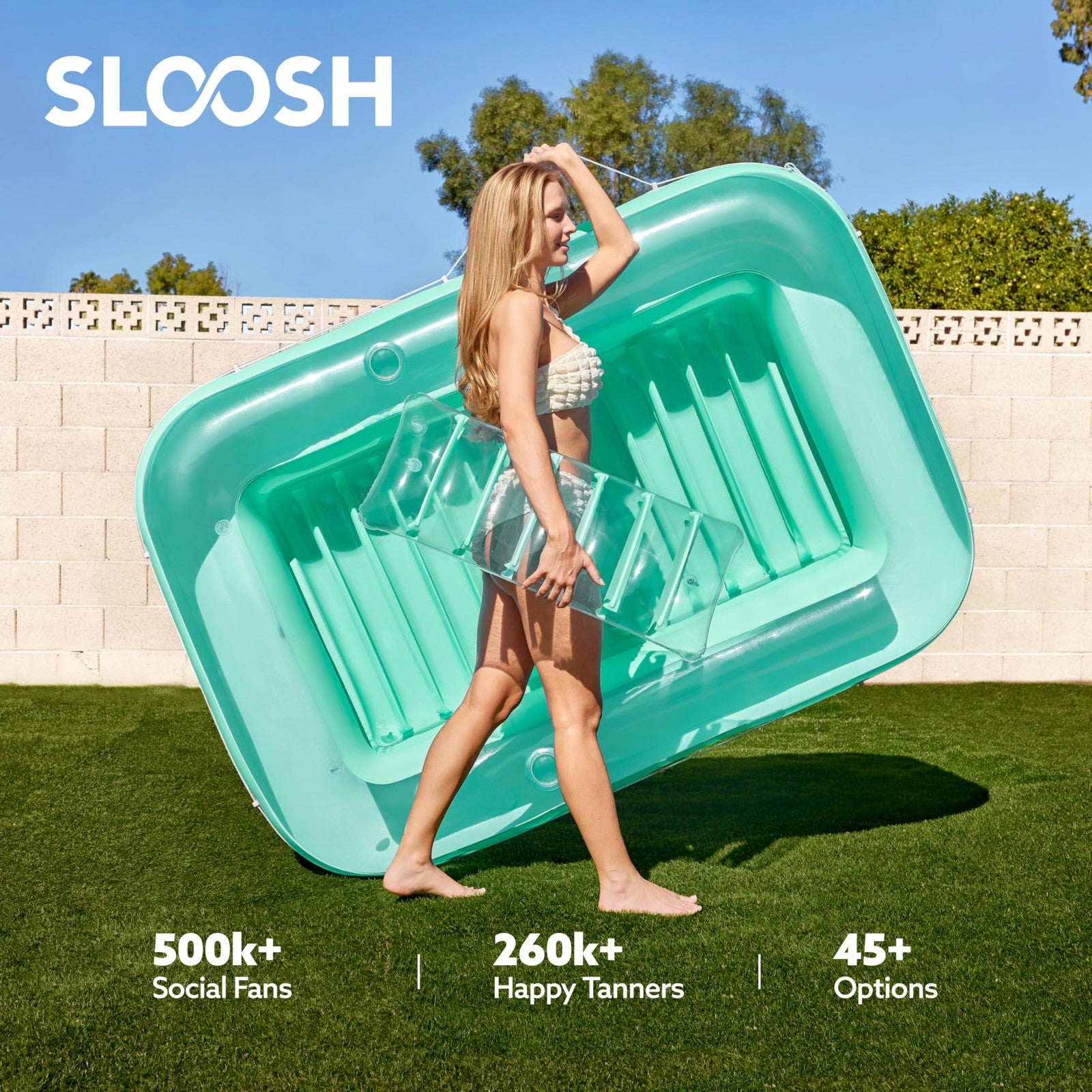 Inflatable SLOOSH tanning pool lounger float with pillow and cupholder, 70x46 inches, designed for adult relaxation in the pool.