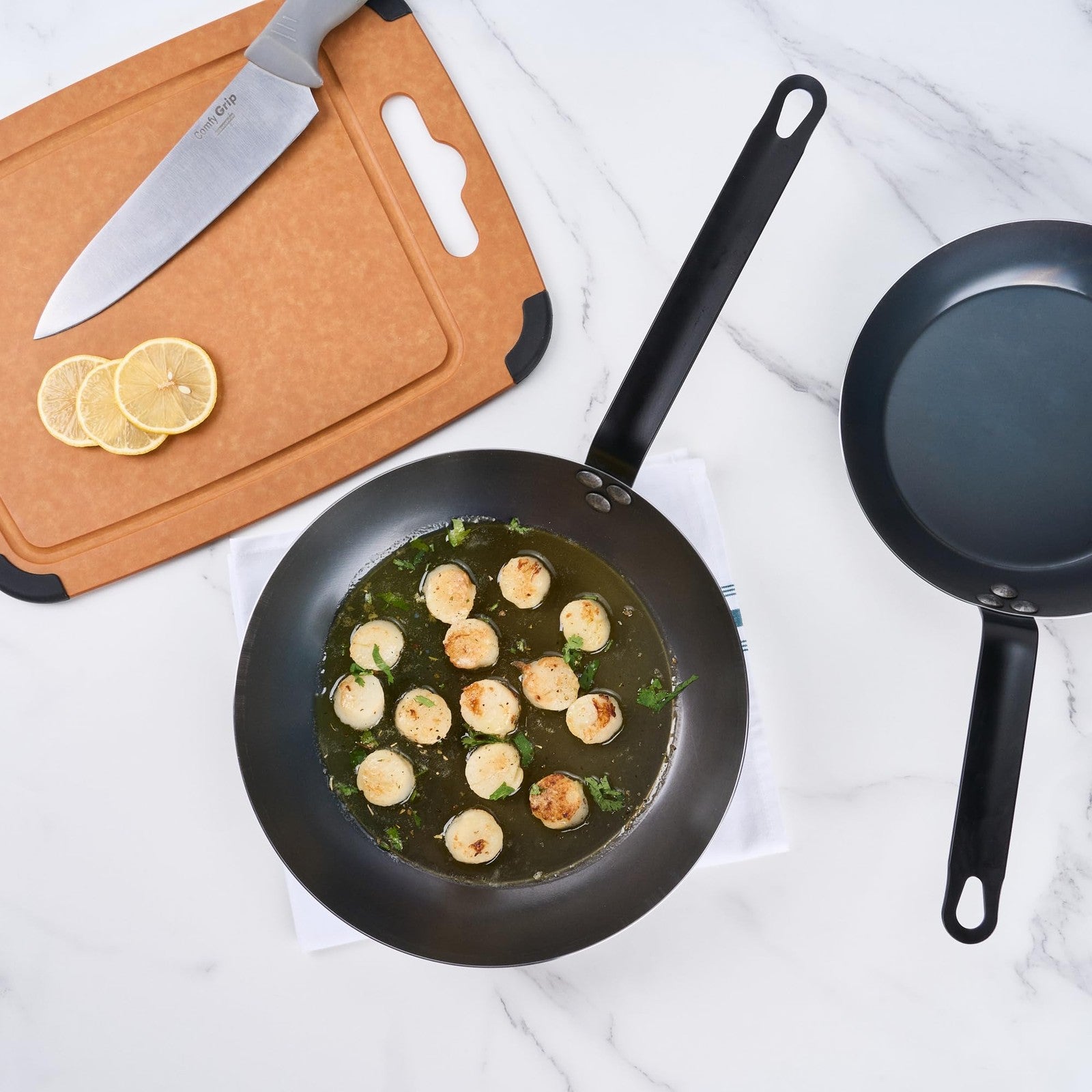 Restaurantware Met Lux 11-inch lightweight frying pan with triple-rive induction-ready surface, shown in a kitchen setting.