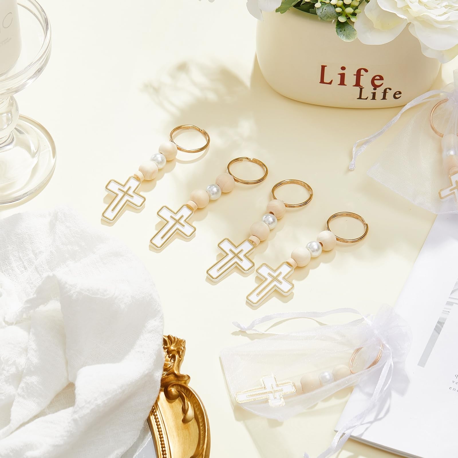 Set of 50 Quelay First Holy Communion rosary beads with crosses and crucifixes, arranged in a display.