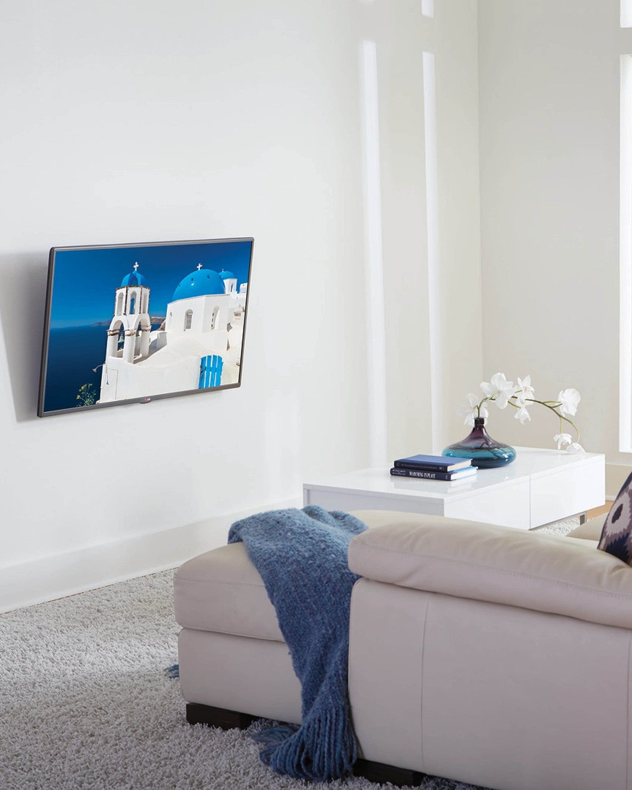 Sanus universal tilting TV wall mount for 32-55 inch TVs, shown installed on a wall with a mounted flat-screen TV.