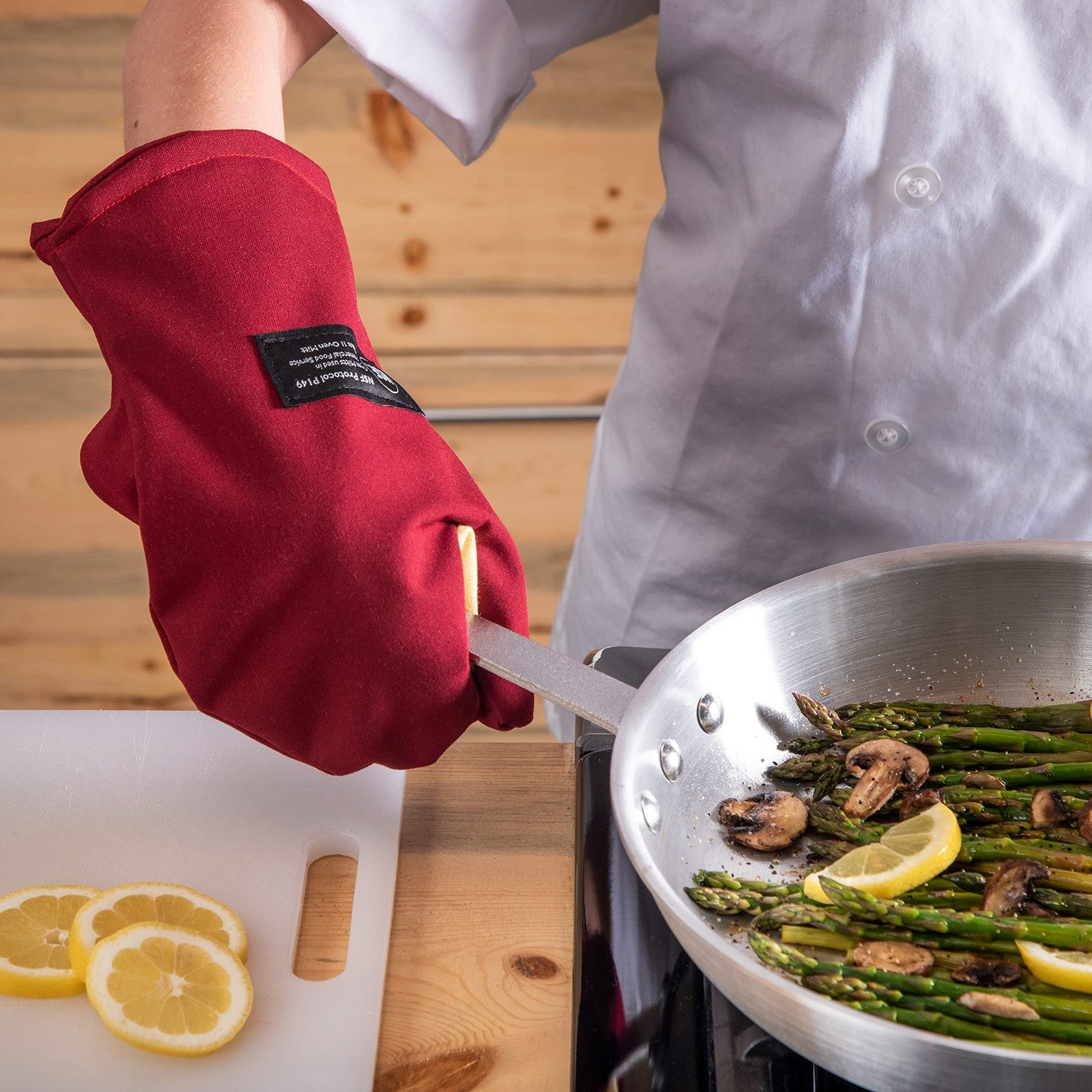 San Jamar Cool Touch Flame oven mitt protecting hands from heat and flames, made of durable heat-resistant material.