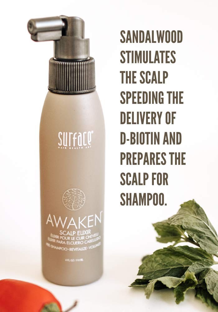 Surface Hair Awaken Therapeutic Scalp Elixir bottle with natural ingredients, designed to help with thinning hair and scalp health.