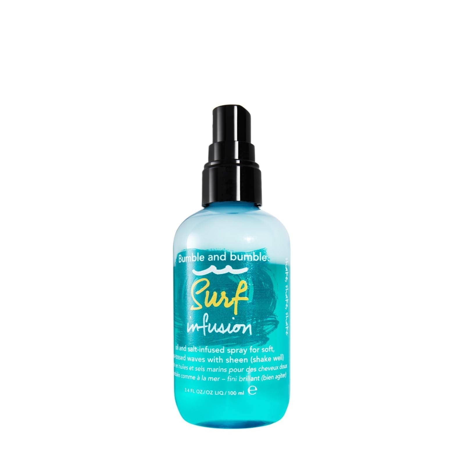 Bumble and bumble Surf Infusion Sea Salt Spray bottle for adding texture and conditioning to hair, with a sandy beach background.