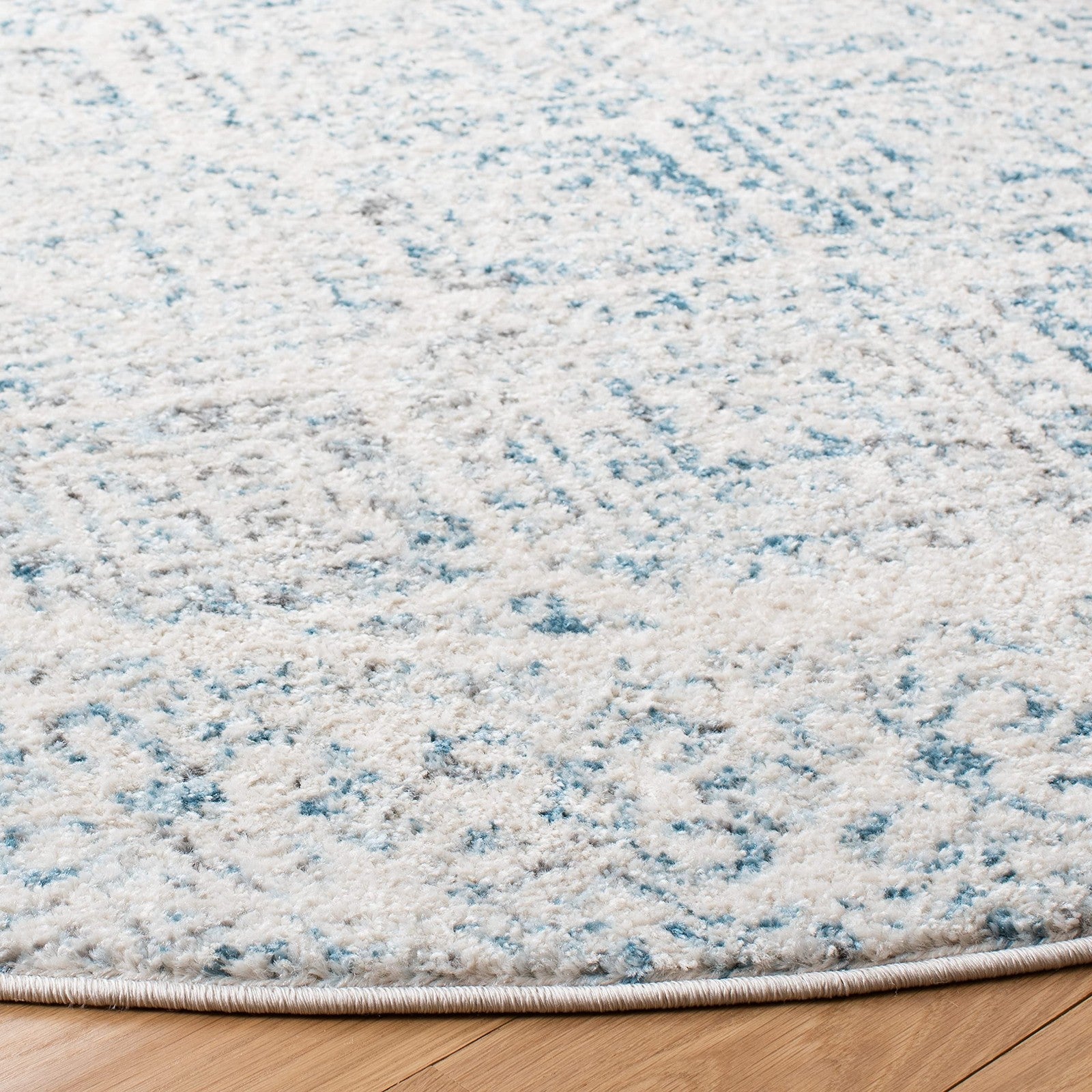 Safavieh Tulum Collection round area rug with ivory and turquoise Moroccan boho pattern, showcasing intricate design and vibrant colors.