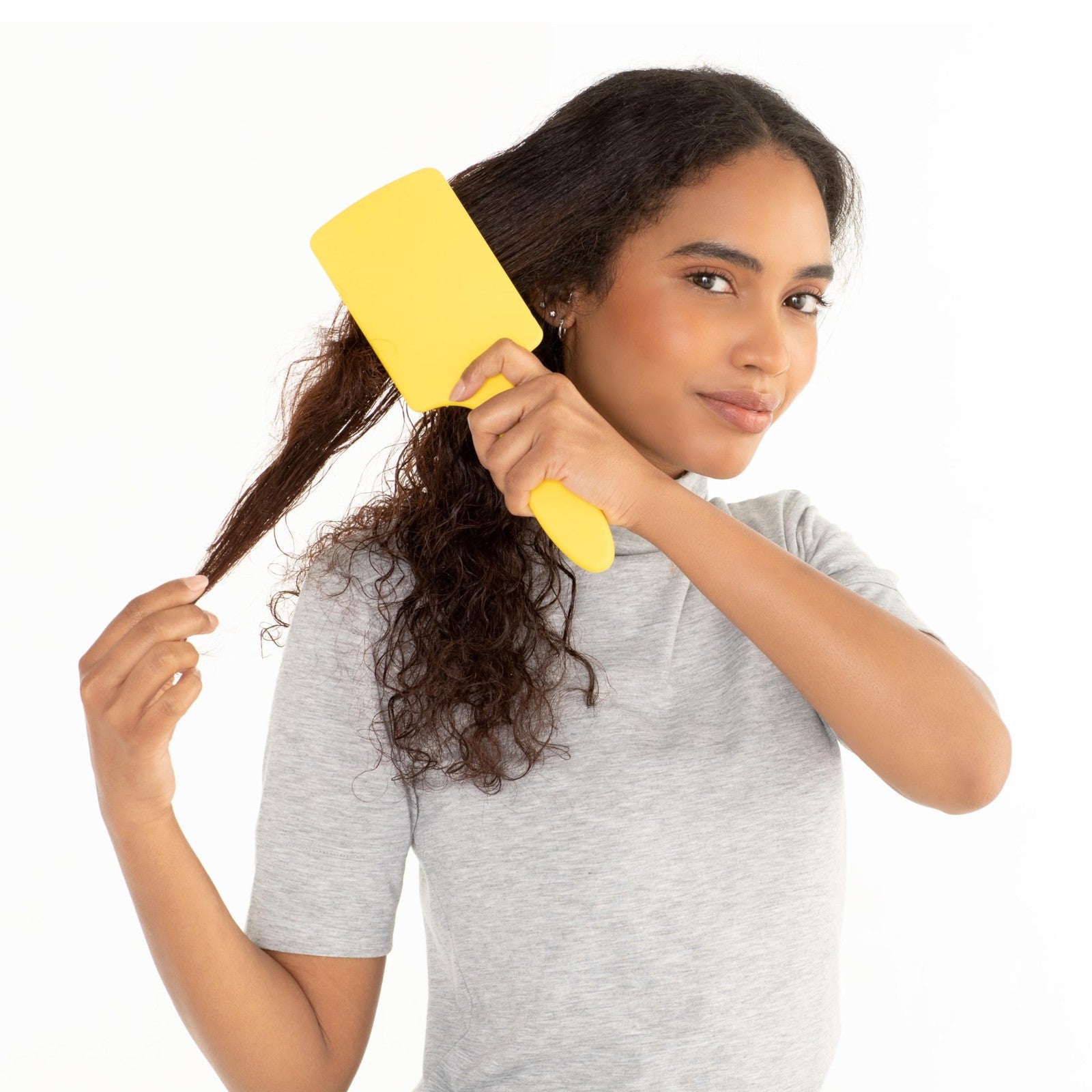 Drybar The Lemon Bar paddle brush with yellow handle and wide bristles for smooth, detangling hair styling.