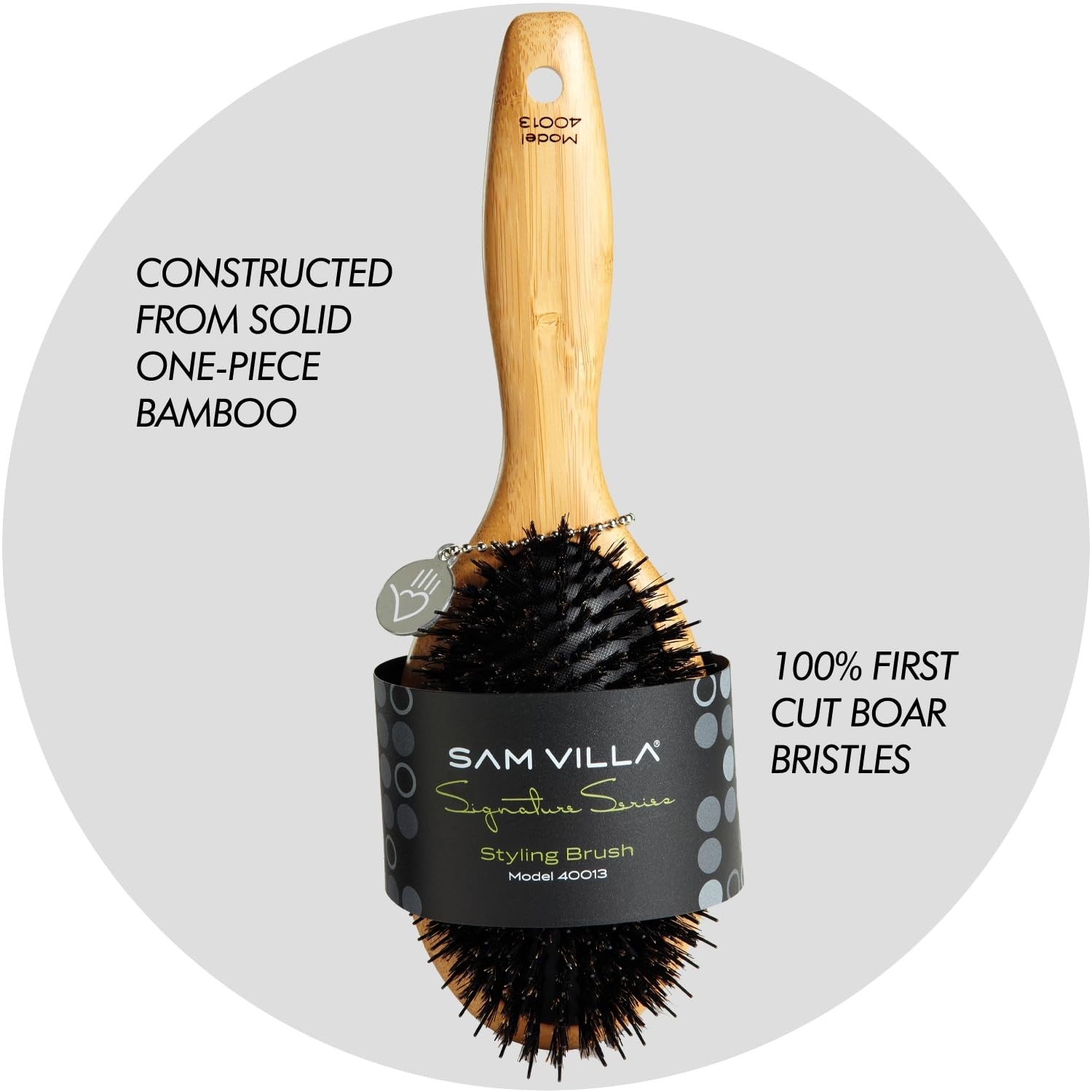 Sam Villa Signature Series boar bristle hair brush for styling, showing natural bristles and ergonomic handle for smooth hair grooming.
