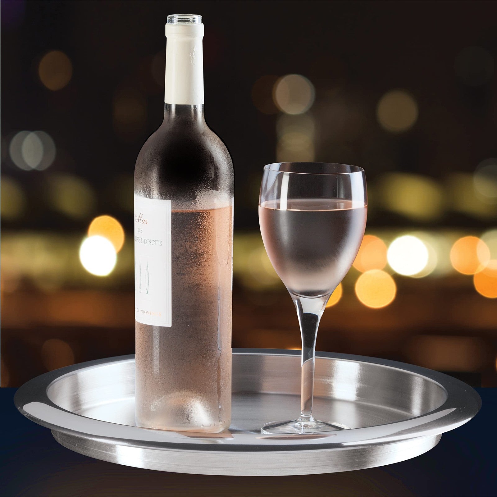 Oggi 14-inch round steel tray used as a decorative coffee table or serving tray for tea and bar accessories.