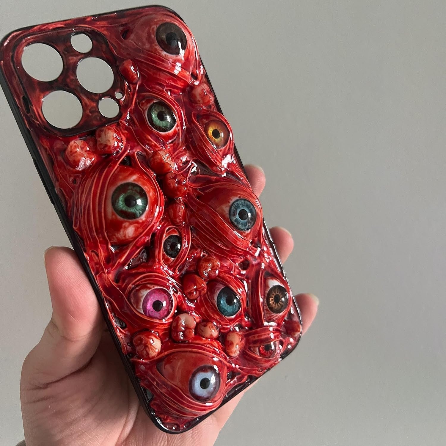 TRADAY creepy horror iPhone 16 Pro phone case with 3D eyes design, featuring a spooky and realistic horror-themed pattern.