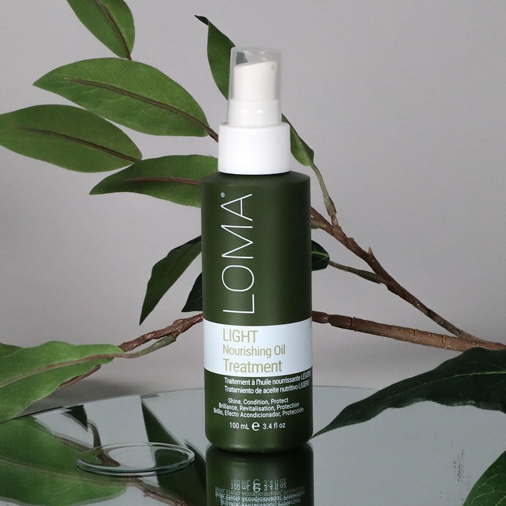 Loma Nourishing Oil Treatment Light bottle with dropper cap, clear liquid inside, on a white background.