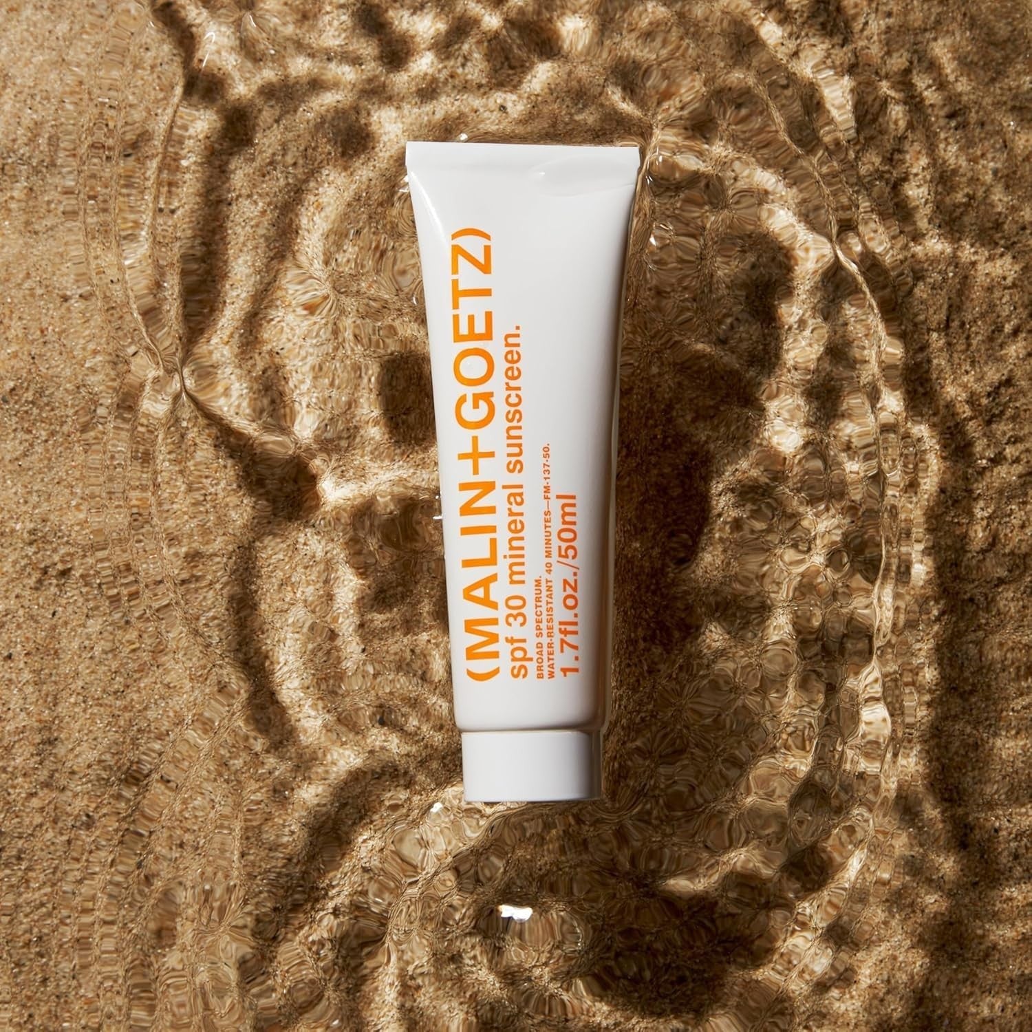 MALIN+GOETZ SPF 30 Mineral Sunscreen tube, broad spectrum sun protection for face and body, with a clean, minimalist design.