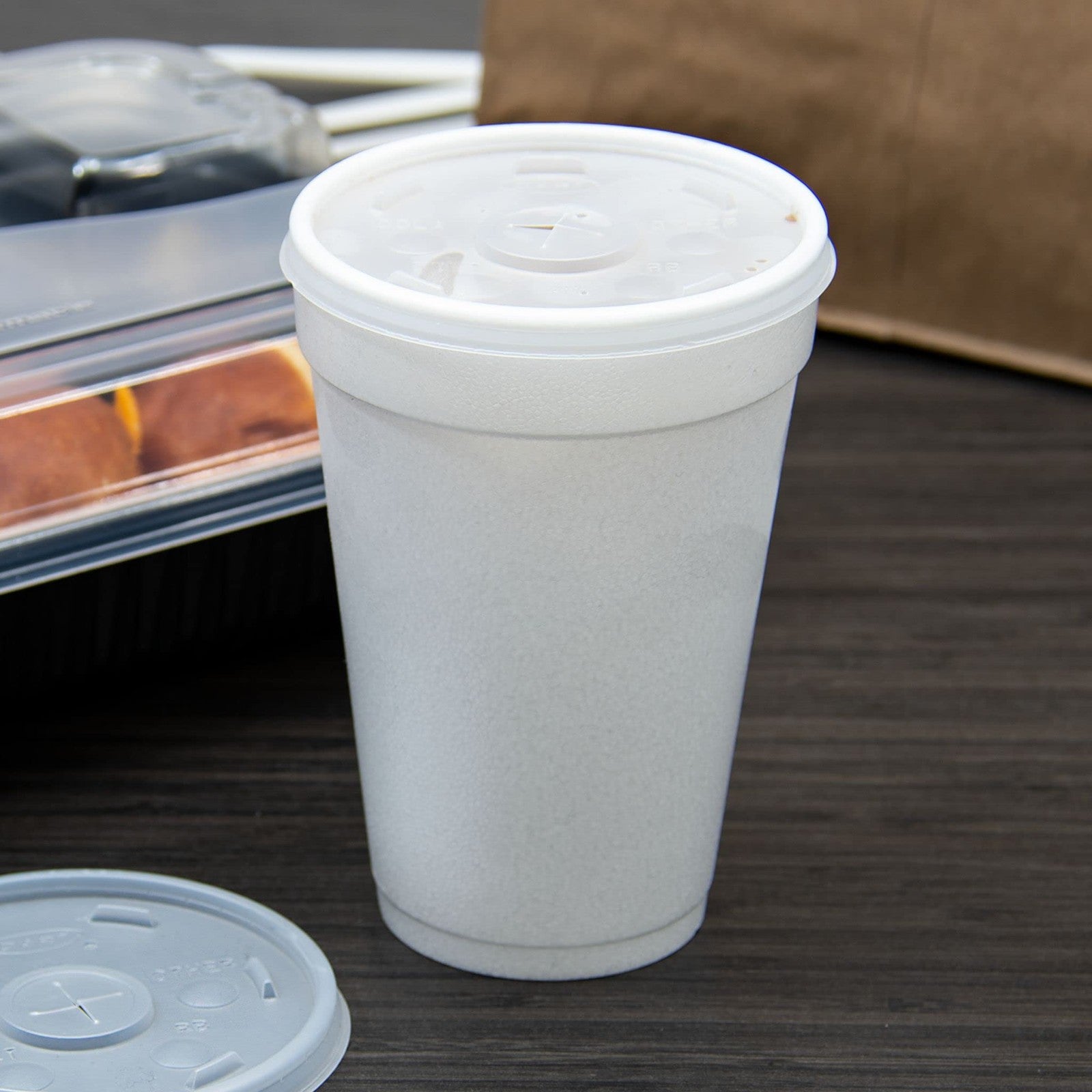 DART translucent slotted foam cup lid for 16 oz cups, designed for hot beverages, with a slotted opening for sipping.