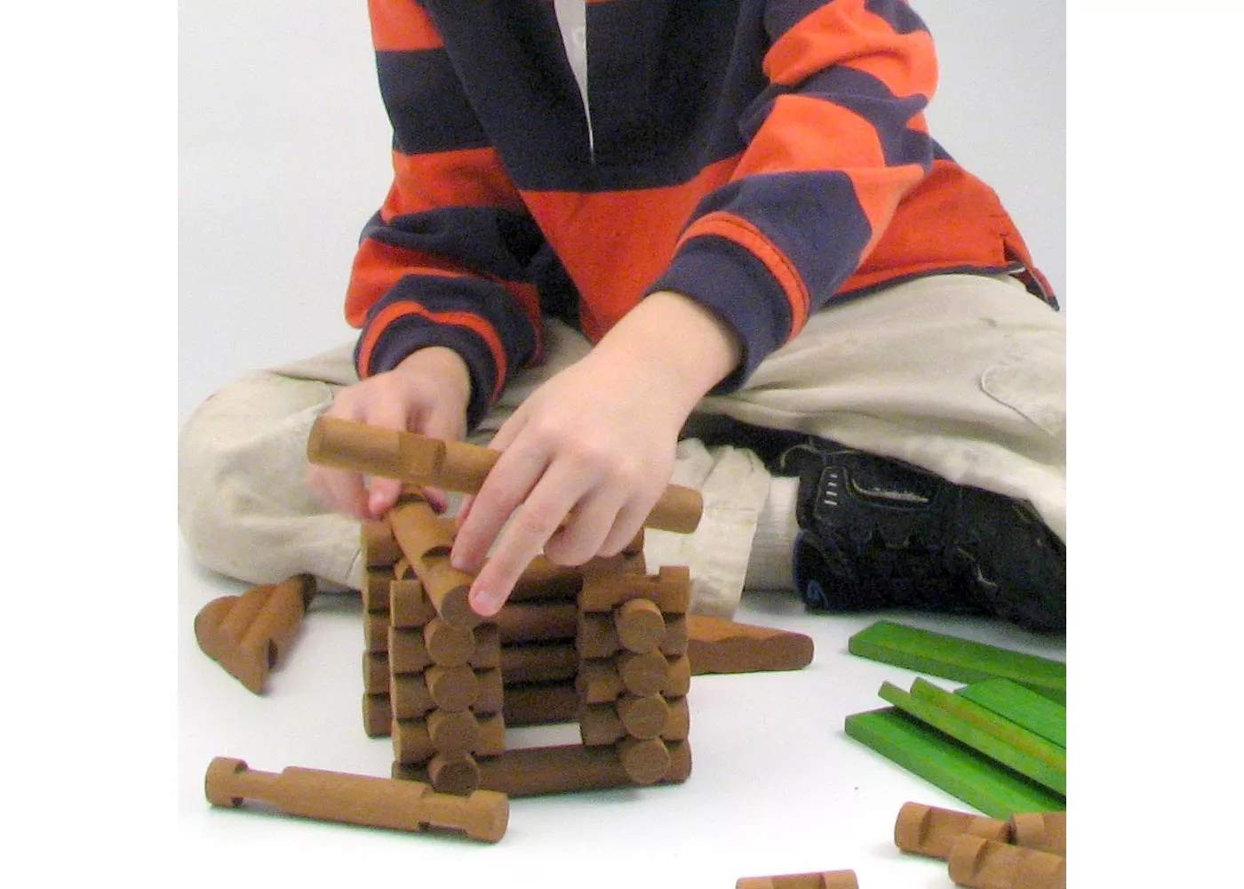 Maxim Enterprise Tumble Tree Timbers wood building set with 450 pieces, showing assembled logs and construction in progress.