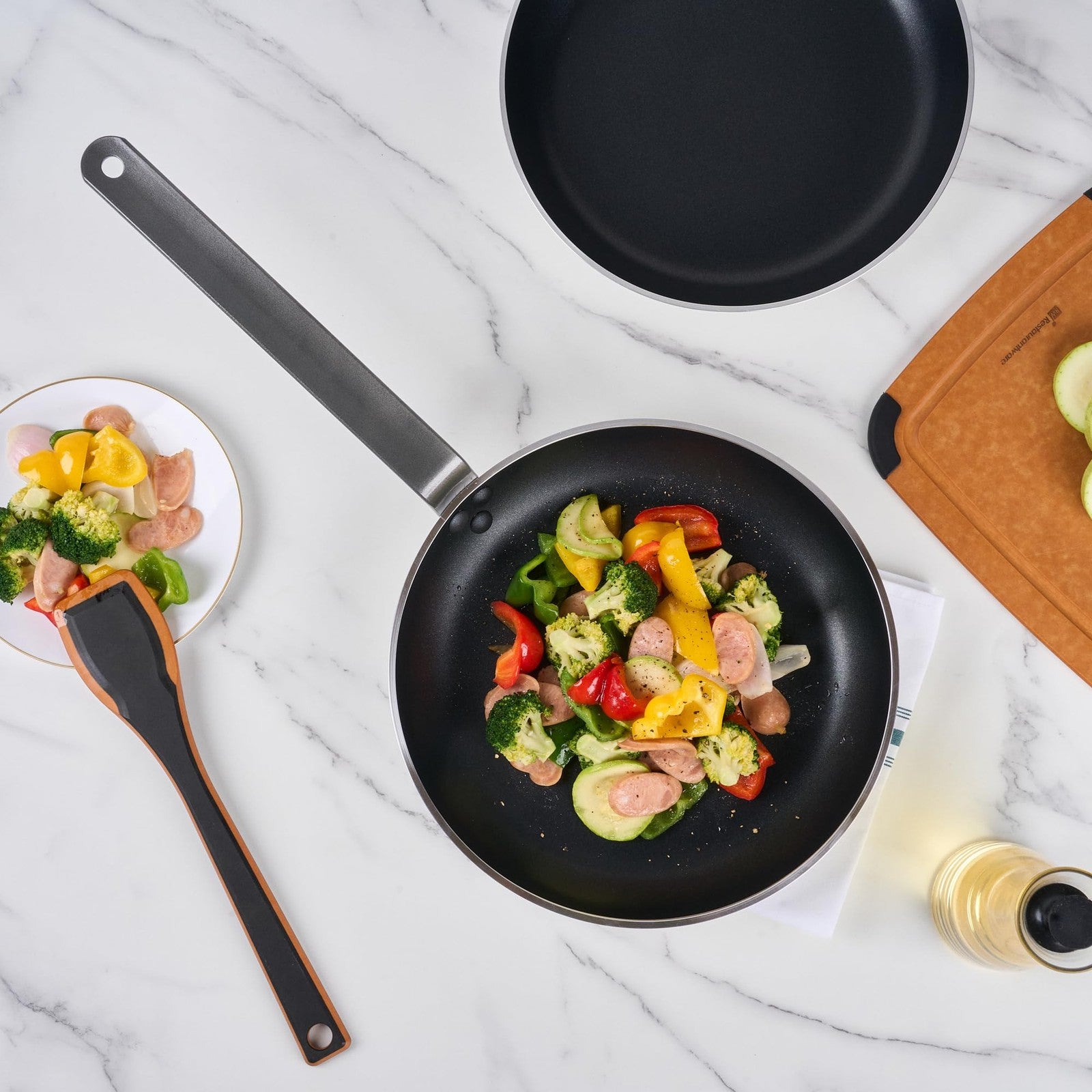 Restaurantware Met Lux 12-inch lightweight frying pan with triple-rive induction-ready design, shown with a sleek black finish.
