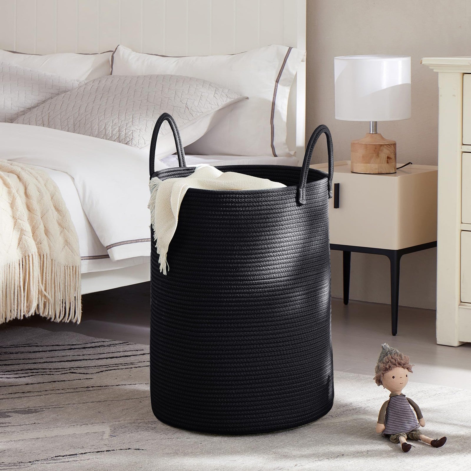 Black woven rope laundry hamper by MOJOSCEND with tall, modern design for clothes storage and organization.