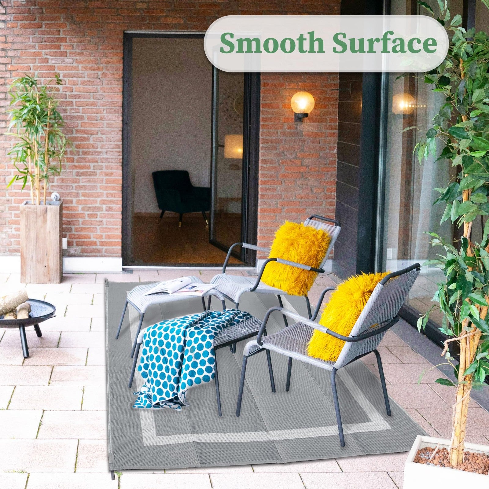 Ogrmar 6x9 ft reversible outdoor patio rug with waterproof plastic straw pattern, ideal for outdoor garden and patio spaces.