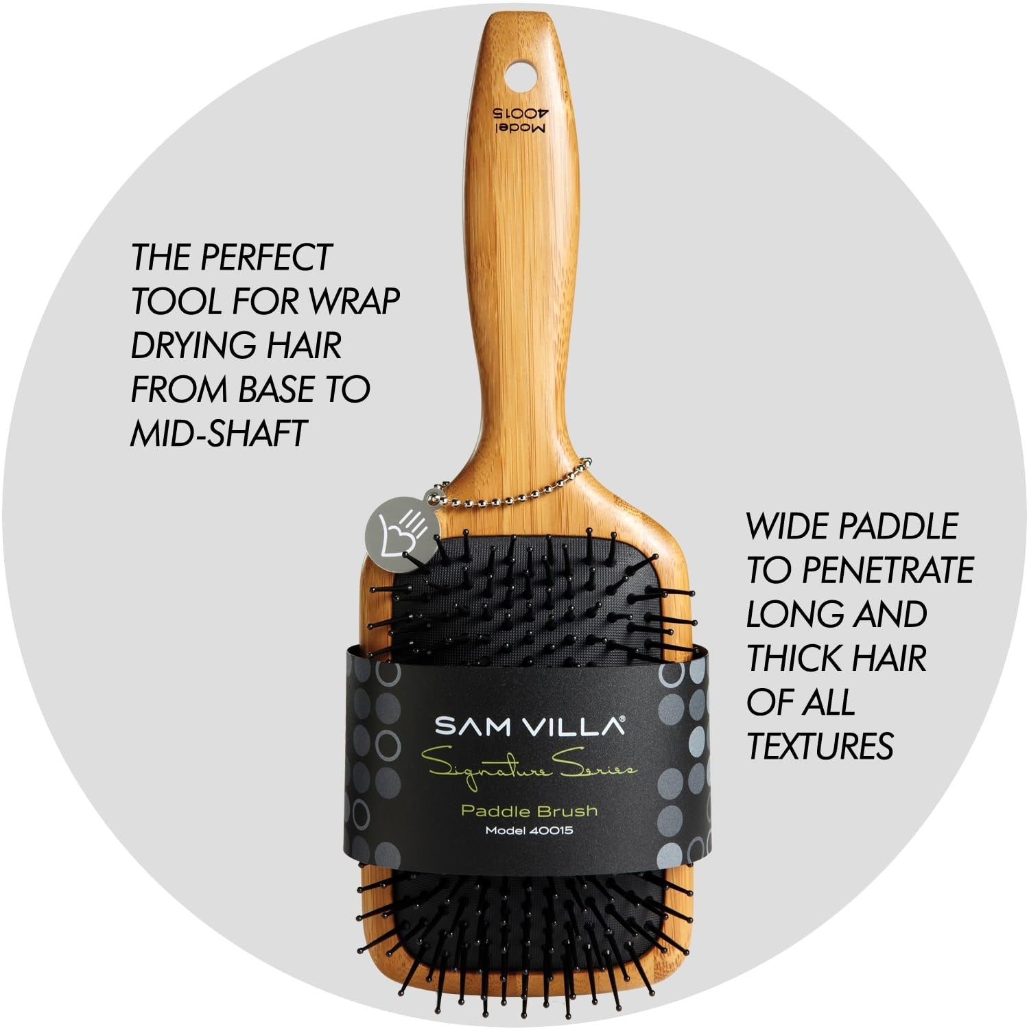 Sam Villa Signature Series bamboo paddle brush for hair styling, featuring wooden handle and wide bristles for detangling and smoothing hair.