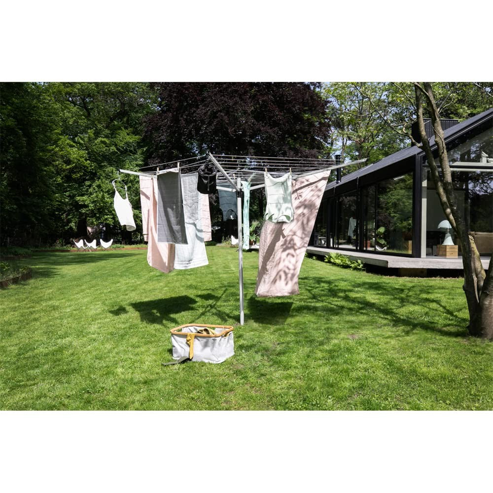Brabantia Lift-O-Matic outdoor 4-arm clothesline with 197ft length, height adjustable, folding design, installed in a backyard setting.