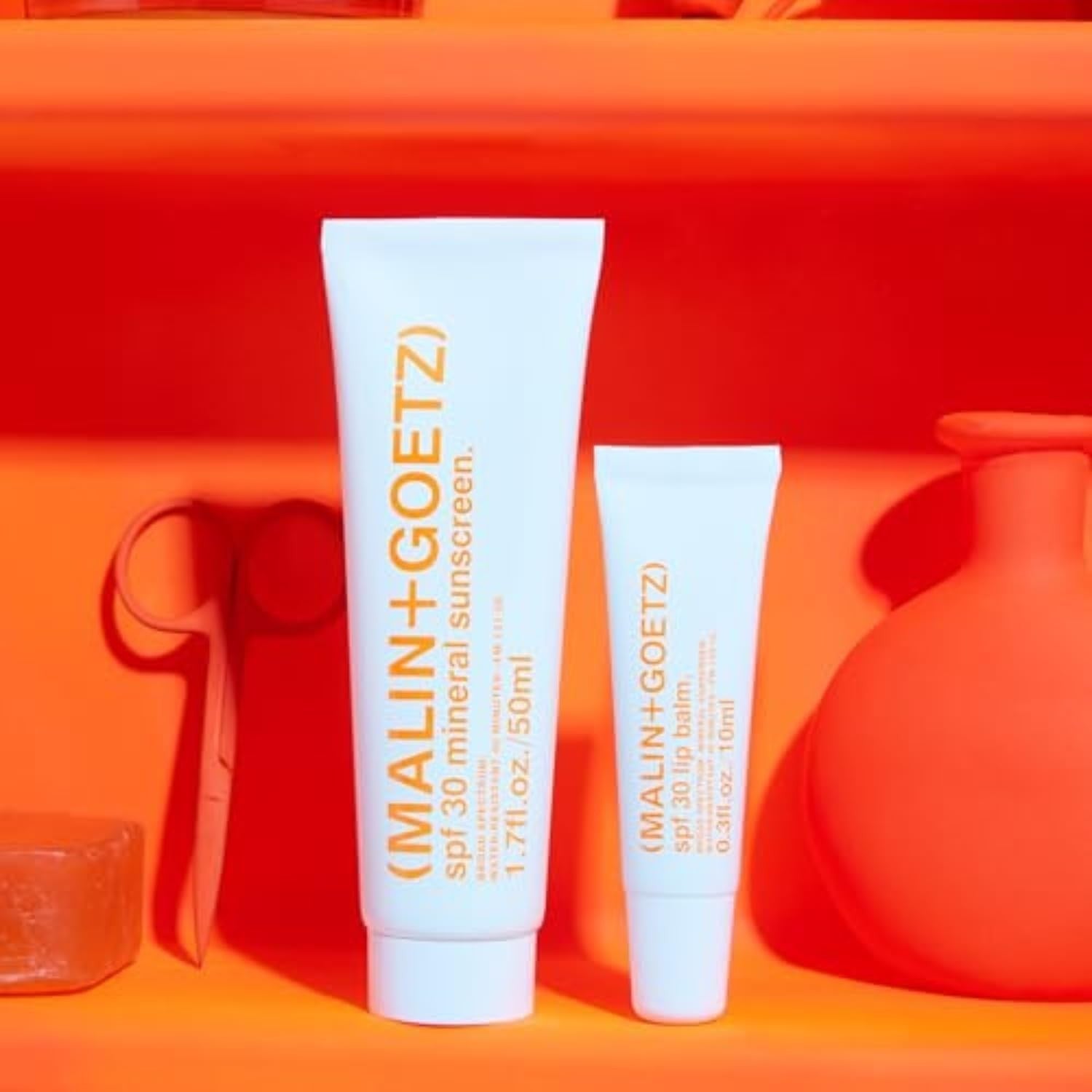 MALIN+GOETZ SPF 30 mineral sunscreen tube, broad spectrum face and body sun protection, white cream with blue cap