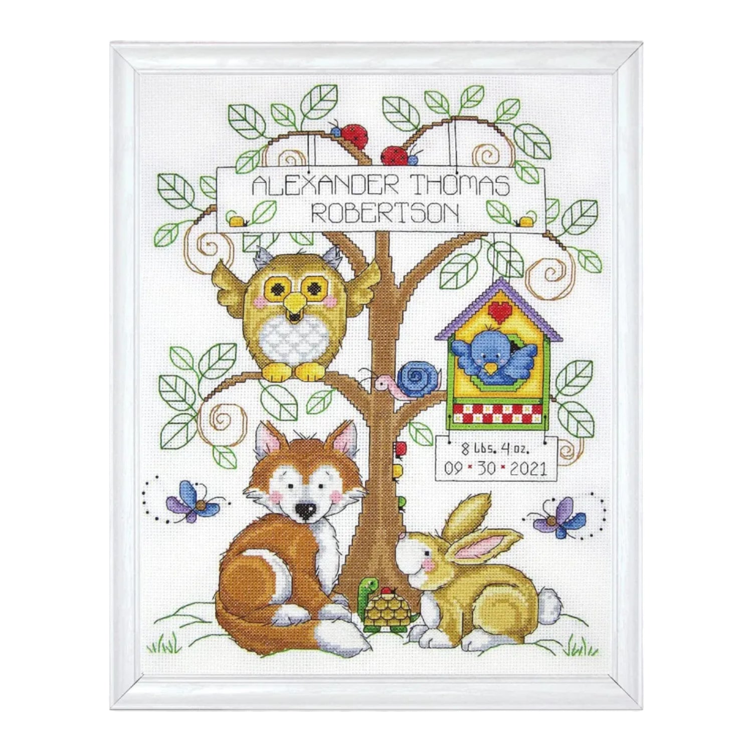 Design Works Crafts Baby's Forest counted cross stitch kit featuring colorful fabric, embroidery floss, and pattern for baby-themed embroidery.