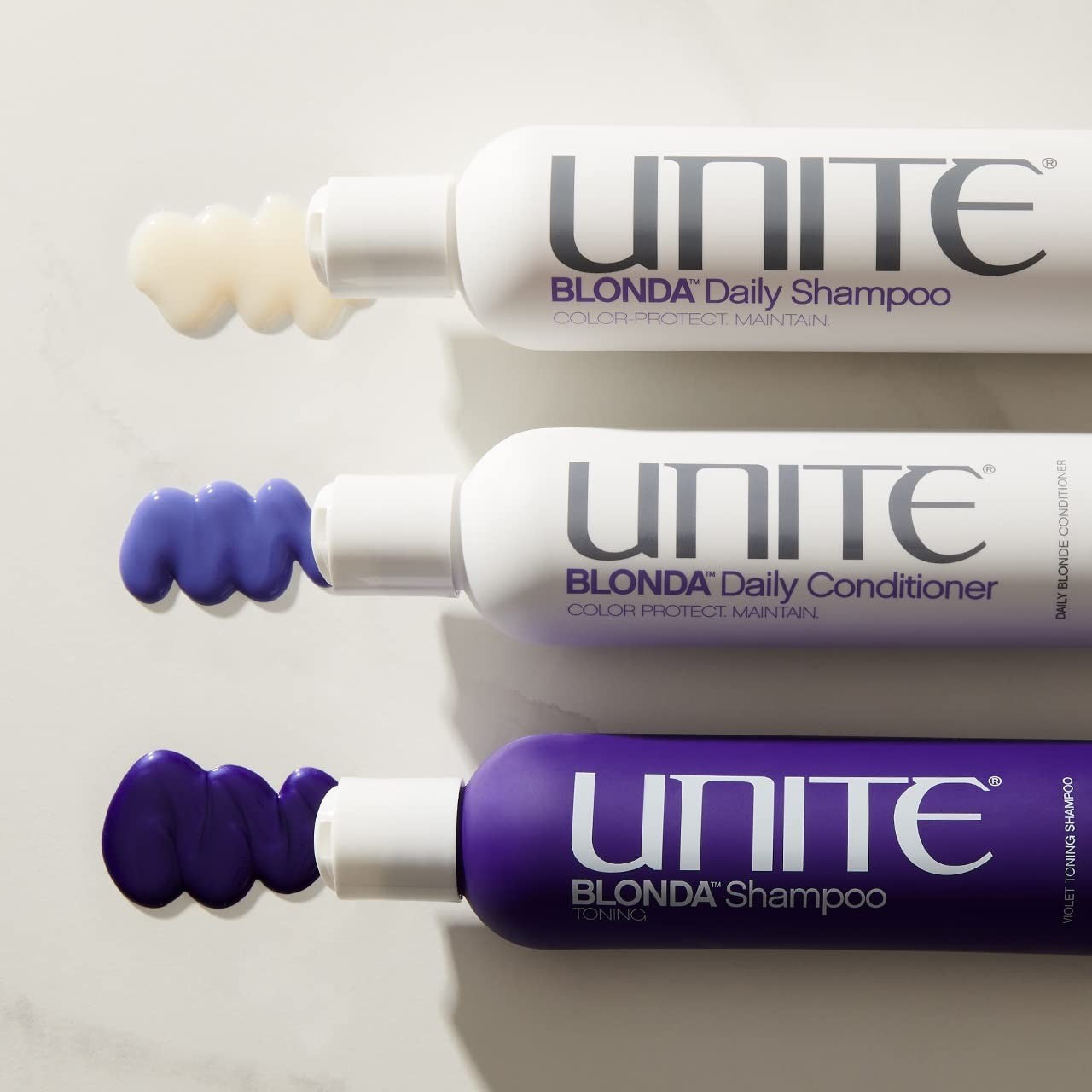 UNITE Hair BLONDA Daily Conditioner with purple formula, hydrating conditioner for maintaining blonde hair, visible bottle in the image.
