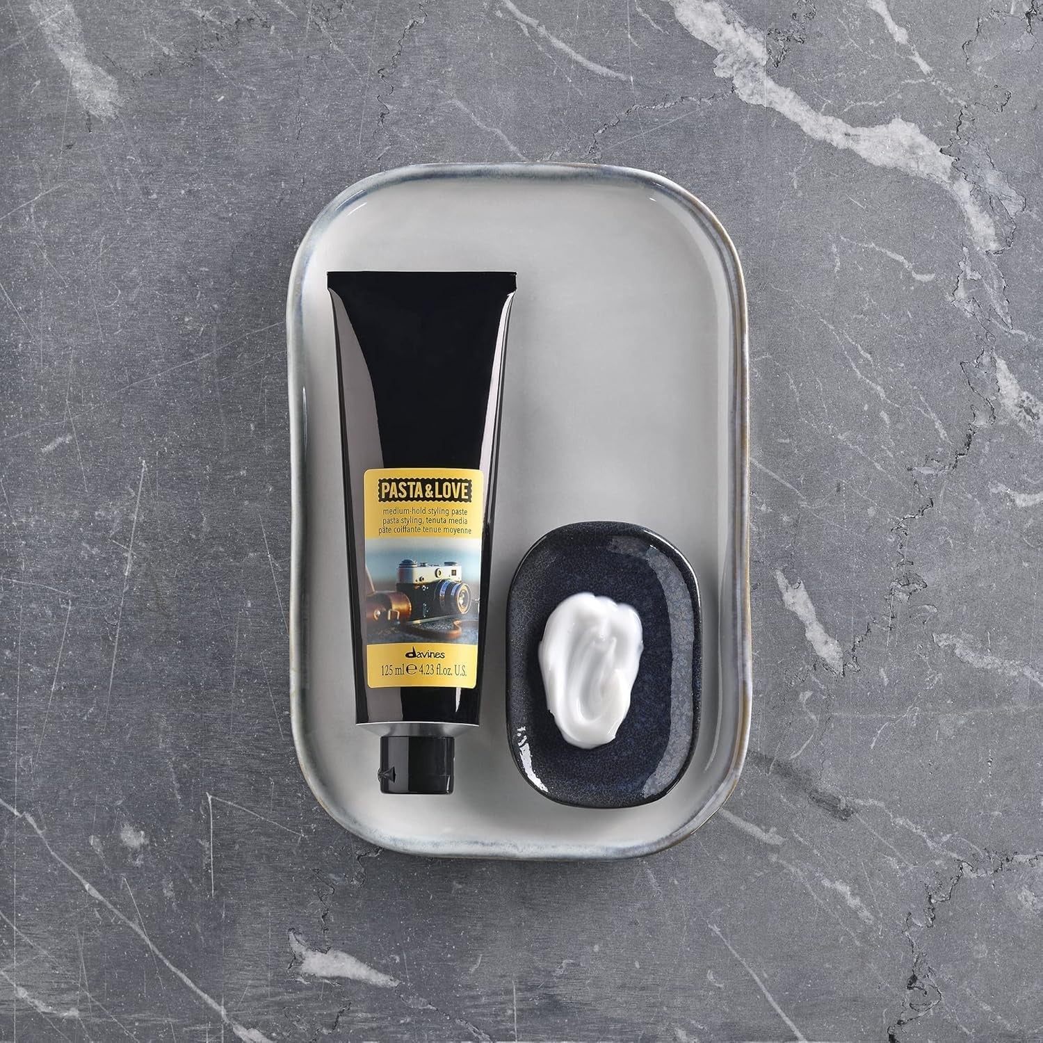 Davines Pasta & Love medium-hold styling paste in a jar, showcasing the natural hair styling product with a smooth, workable texture.