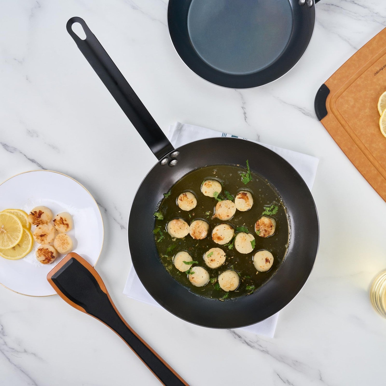 Restaurantware Met Lux 11-inch lightweight frying pan with triple-rive design, induction-ready cookware on a stovetop.