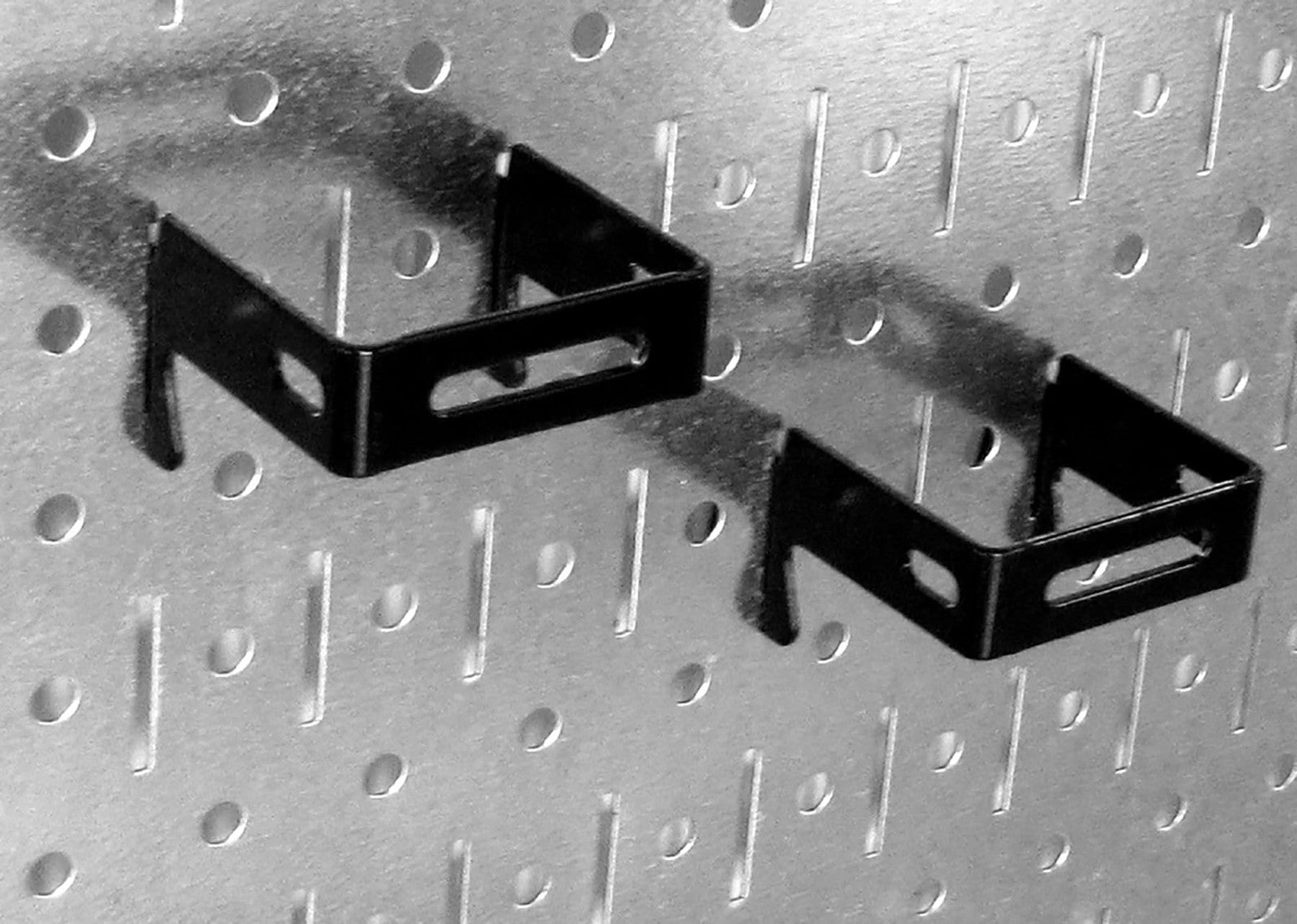 Wall Control 52-piece black steel metal hook assortment on a tool board, showing various hooks for organizing tools.