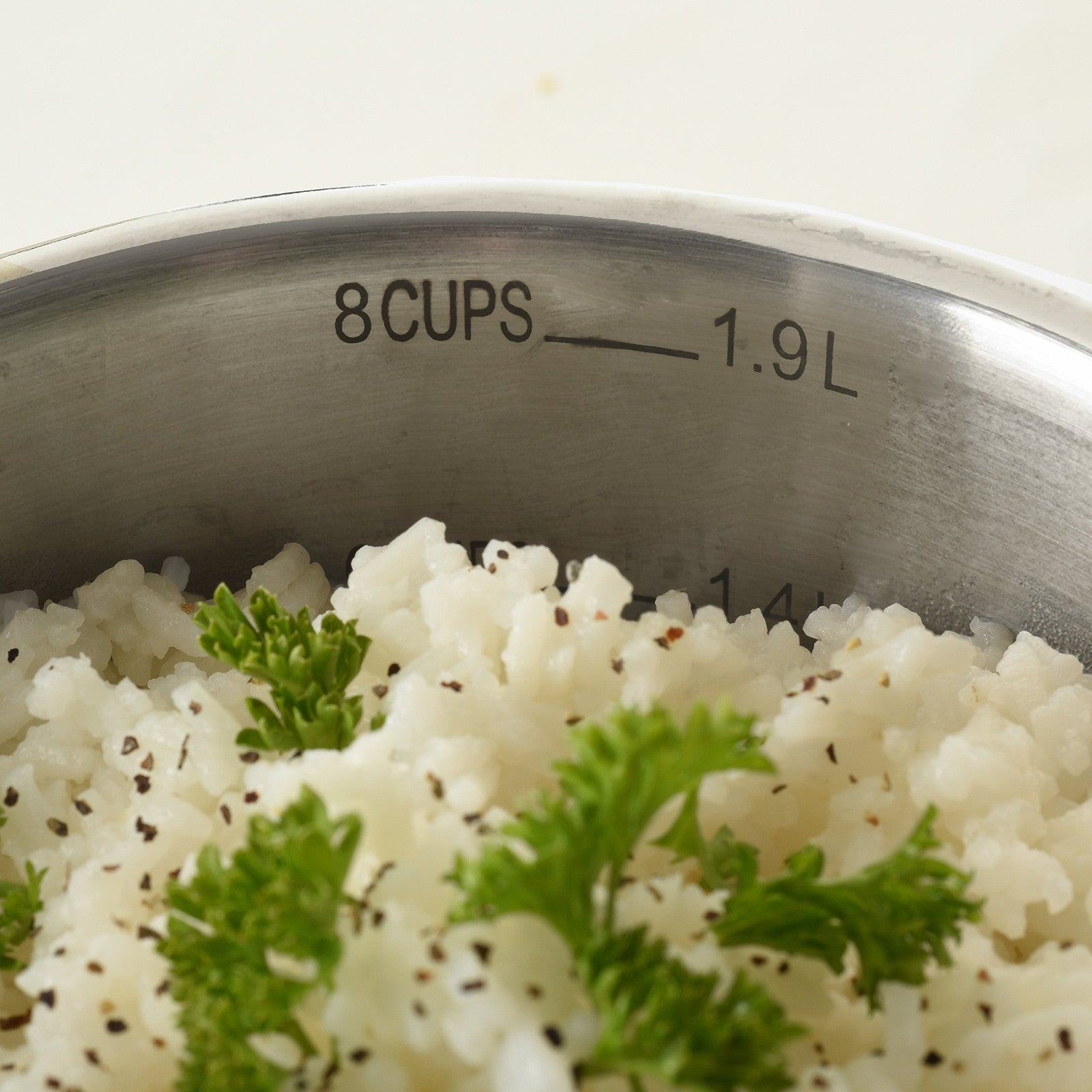 Norpro 8-cup stainless steel multi-pot with straining lid, featuring a sturdy handle and a vented lid for versatile cooking.