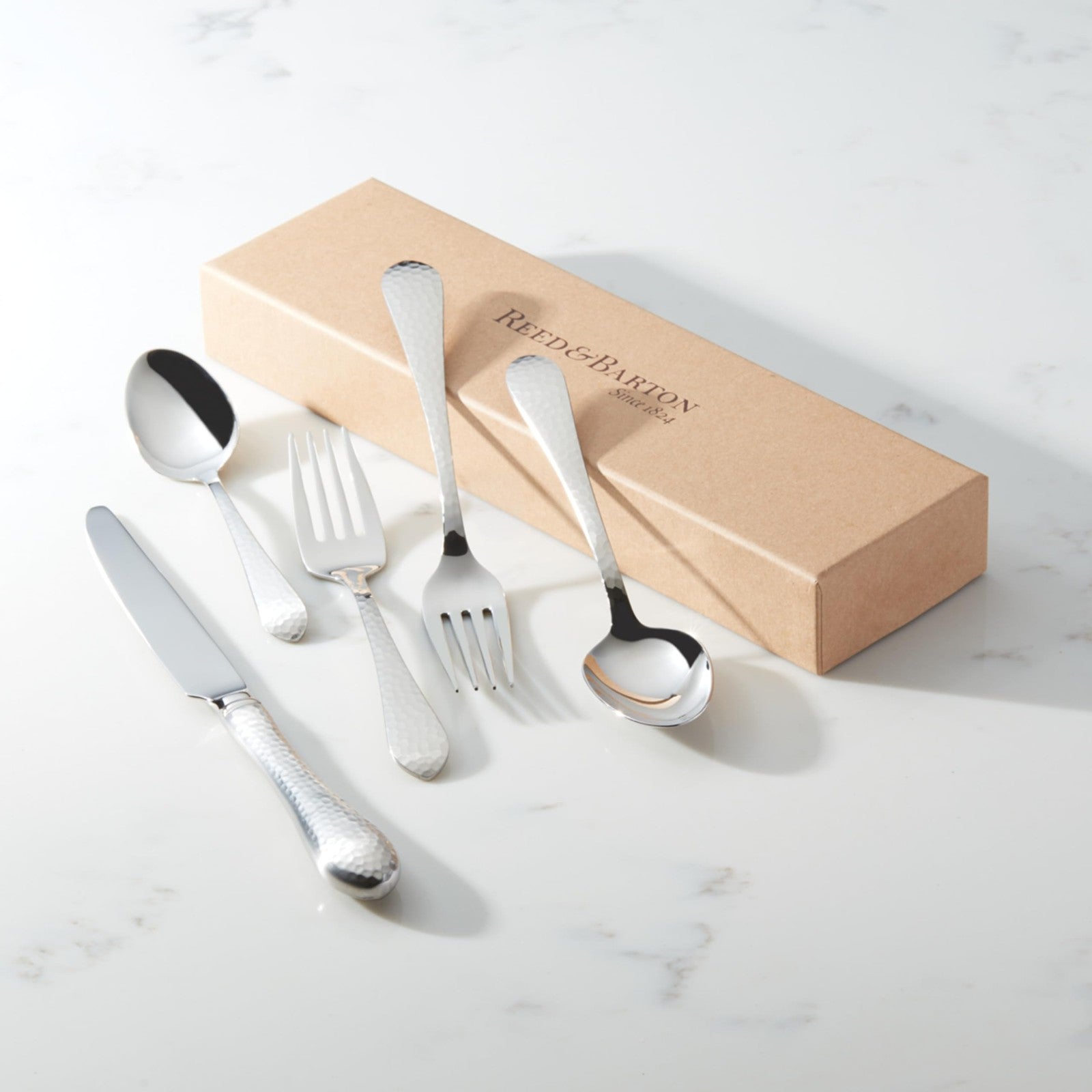 Reed & Barton hammered antique silverware set with five-piece flatware place setting including fork, knife, and spoon.