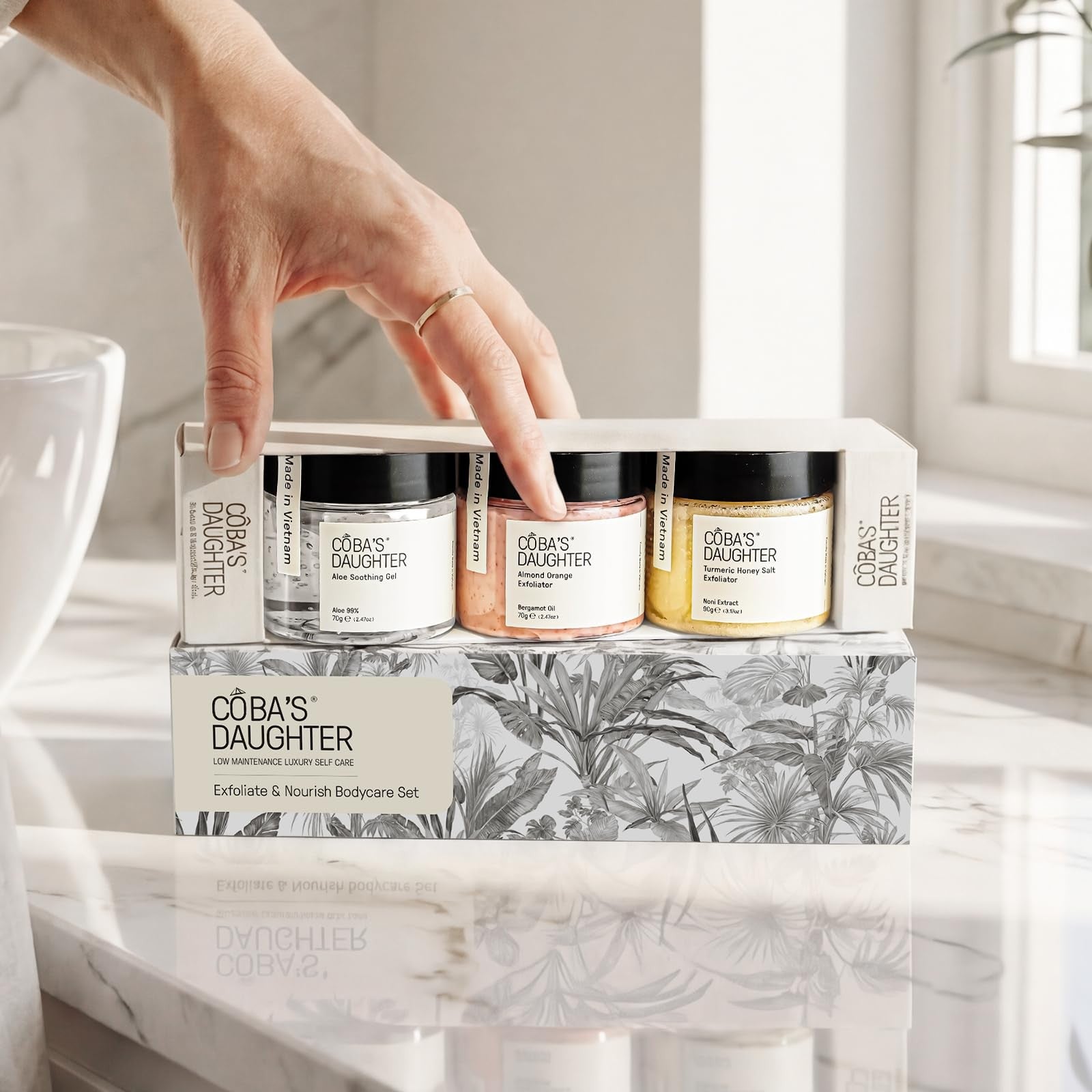 COBA'S DAUGHTER luxury spa gift set for women featuring three mini body care products in elegant packaging.