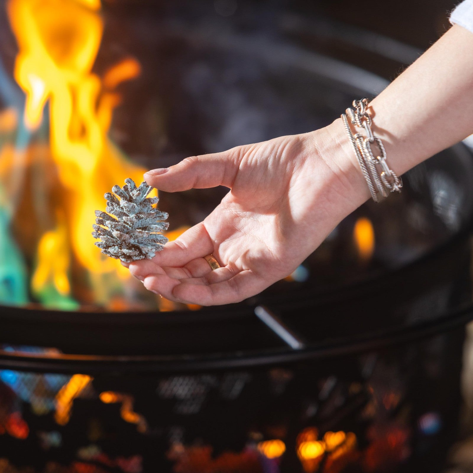 Festive rainbow-colored pine cone fireplace color cones for firepit, featuring vibrant flame-changing effects by Plow & Hearth.