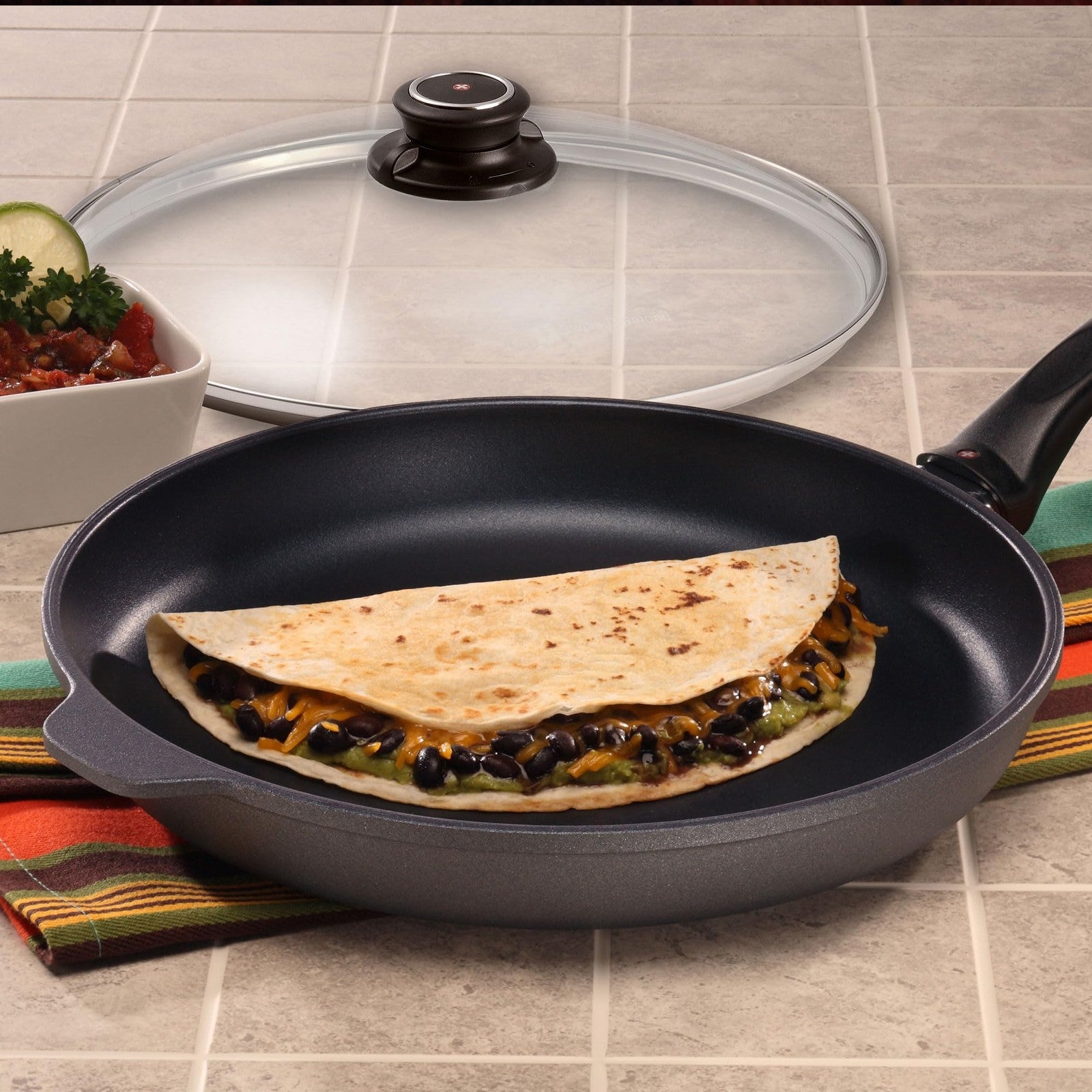 Swiss Diamond nonstick frying pan with lid, featuring durable diamond coating and ergonomic handle for versatile cooking.