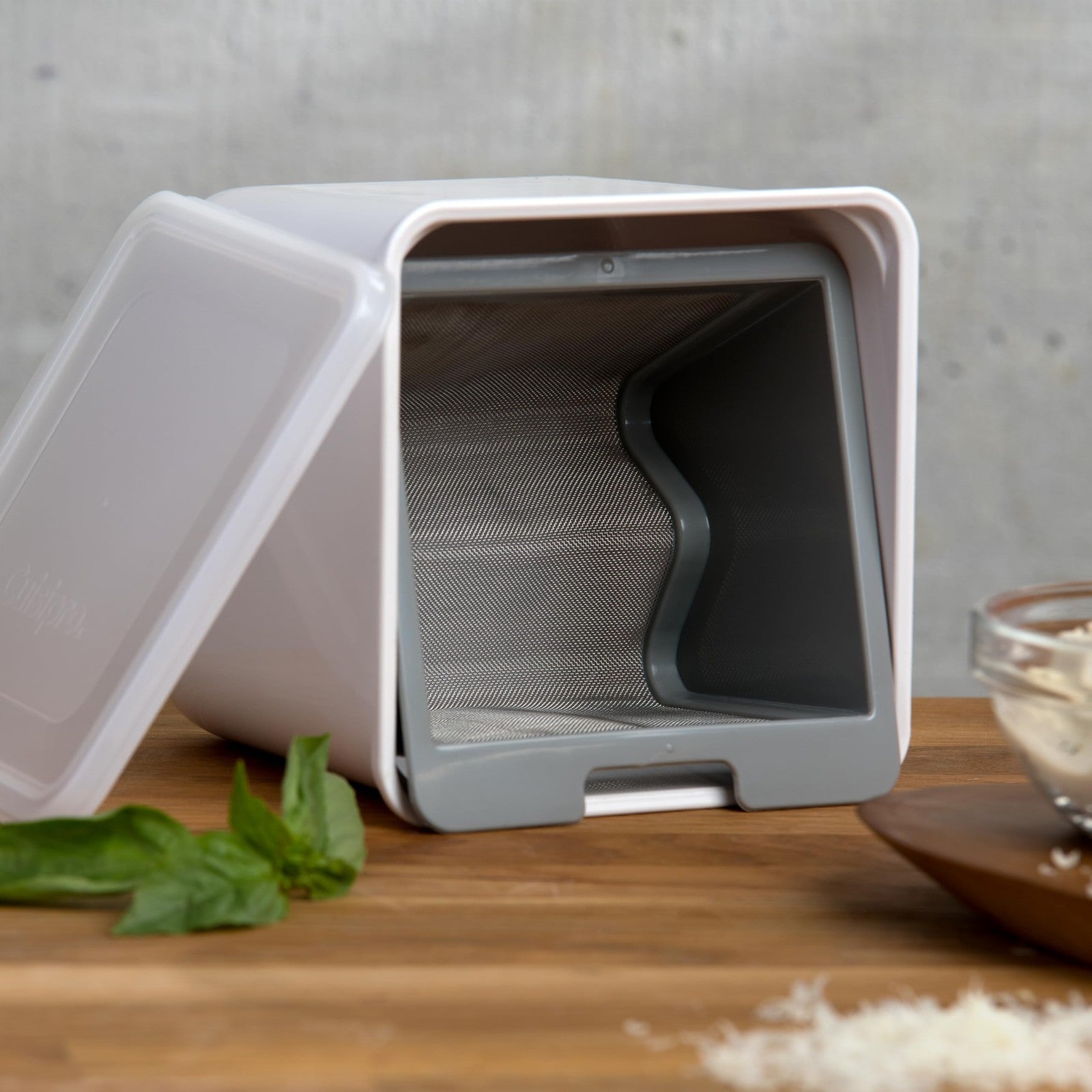 Cuisipro white yogurt cheese maker with a clear lid and collection container, used for homemade yogurt cheese preparation.