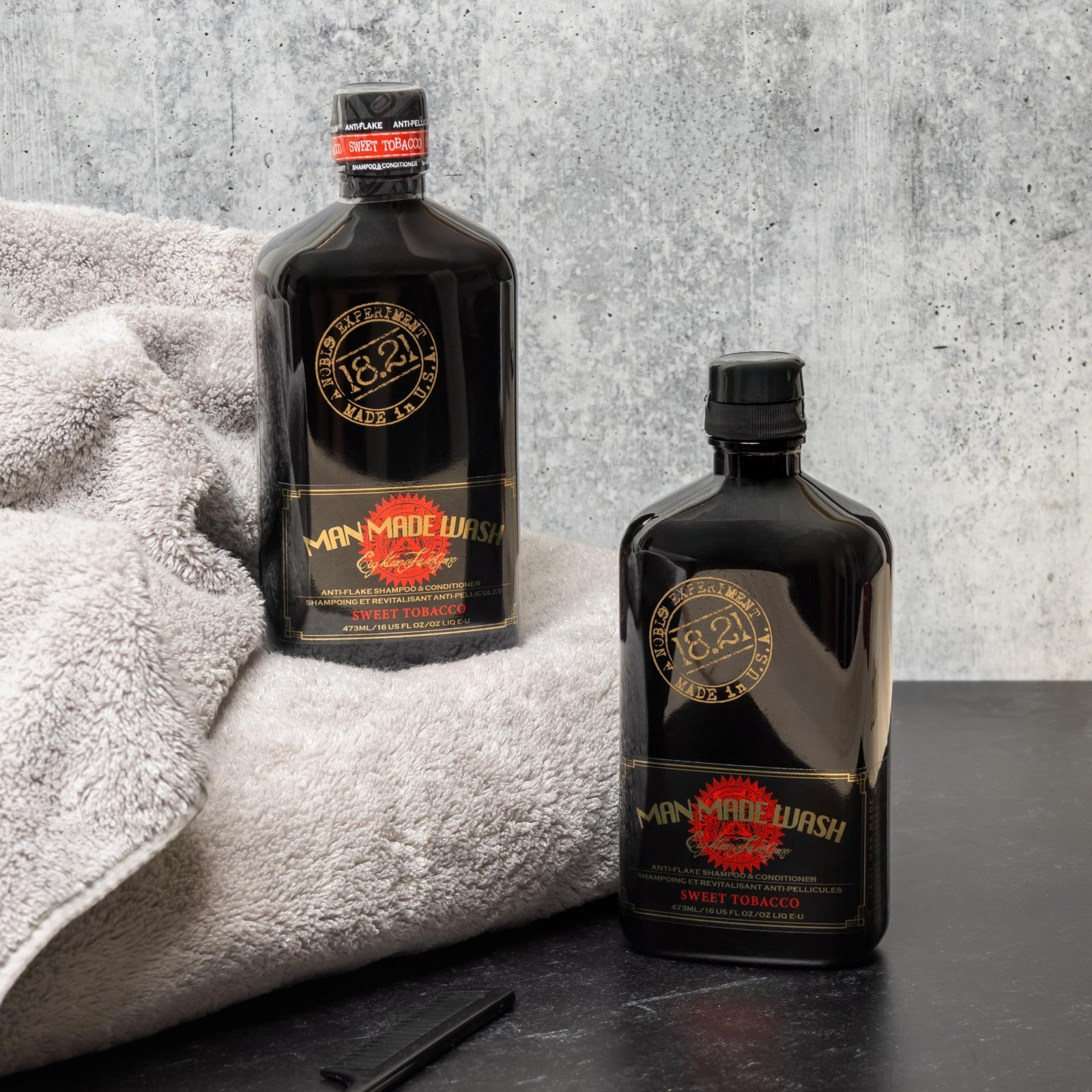 18.21 Man Made Anti-Flake 2-in-1 Shampoo and Conditioner bottle with sleek design and label in Sweet Tobacco scent.