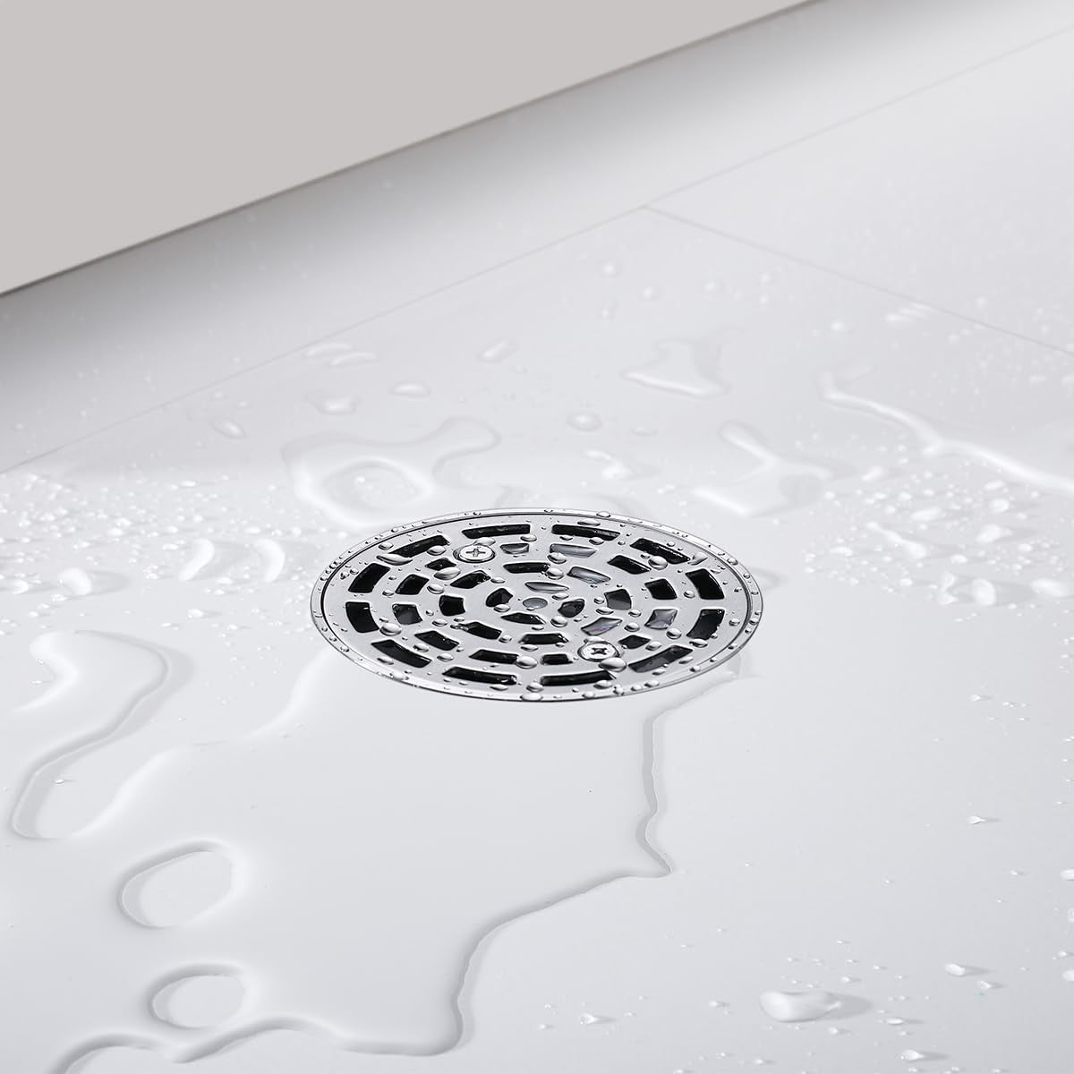 Random round brushed nickel shower drain with adjustable PVC, 4-inch diameter for modern bathroom shower installation.