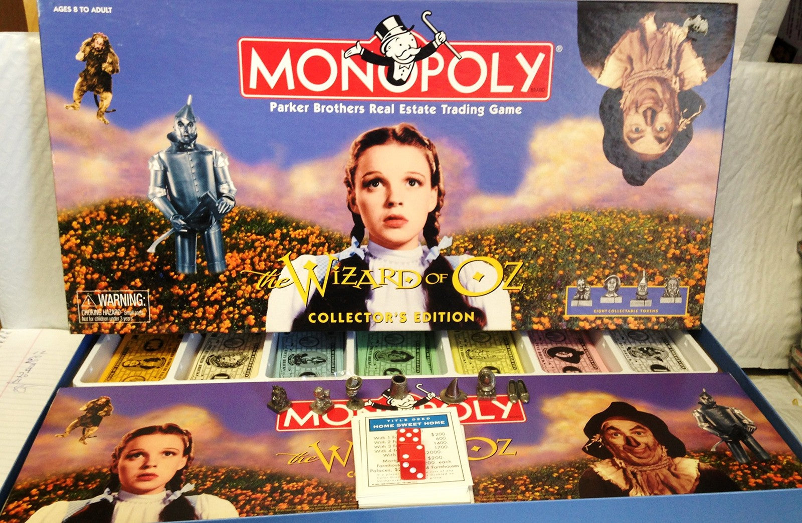 The Wizard of Oz Monopoly game box showing colorful artwork of characters and game pieces from the classic board game.